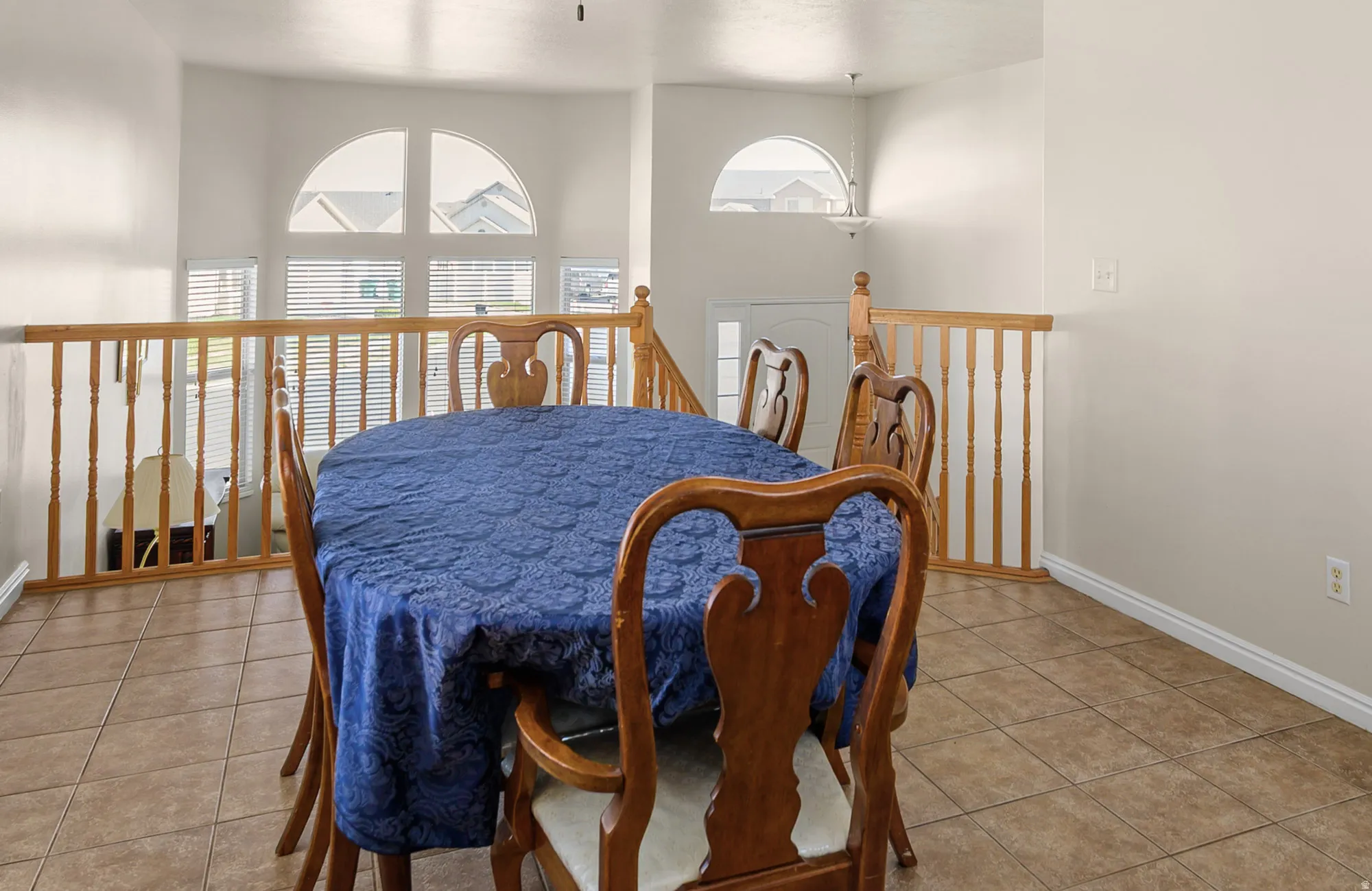 Dining space with light tile patterned floors and baseboards