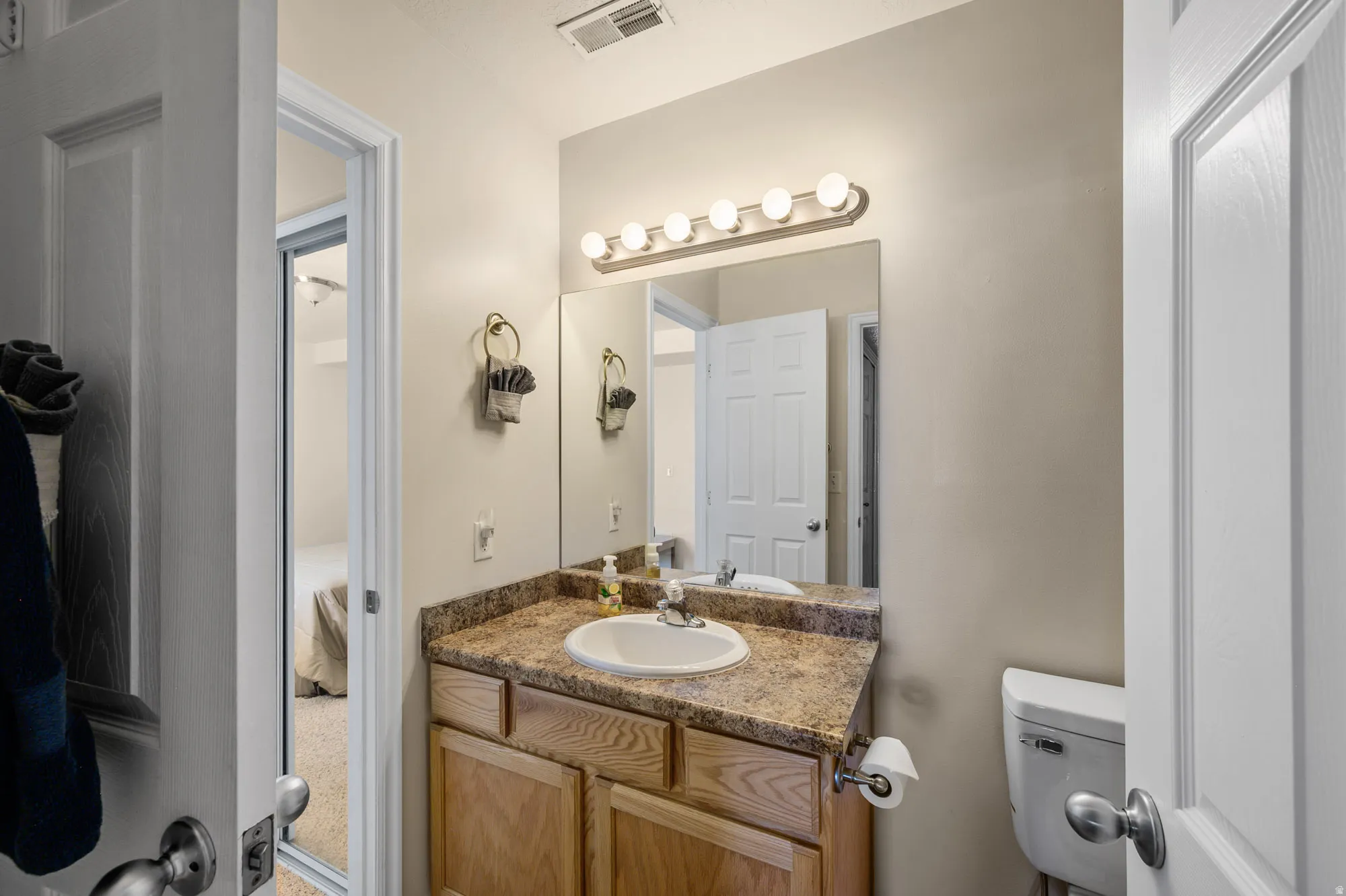 Ensuite bathroom featuring toilet and vanity