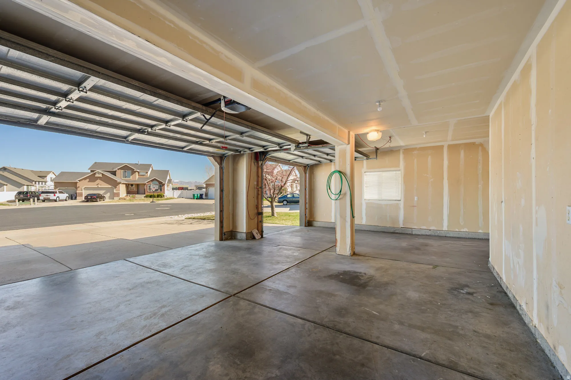 Garage featuring a residential view and a garage door opener