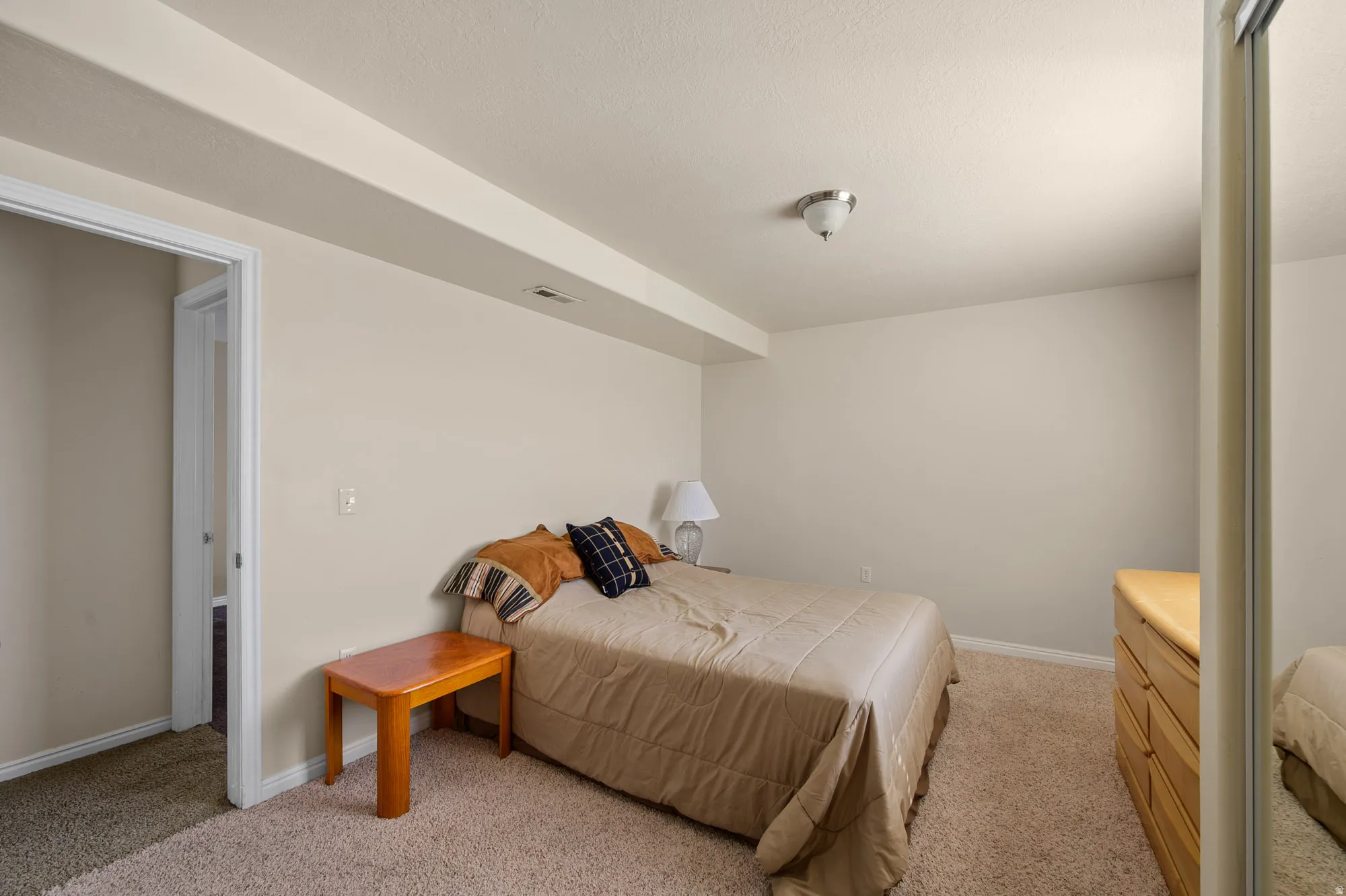 Bedroom featuring light carpet and baseboards
