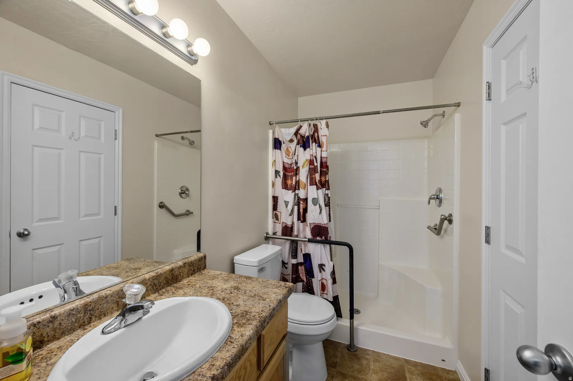 Full bathroom featuring vanity and a stall shower