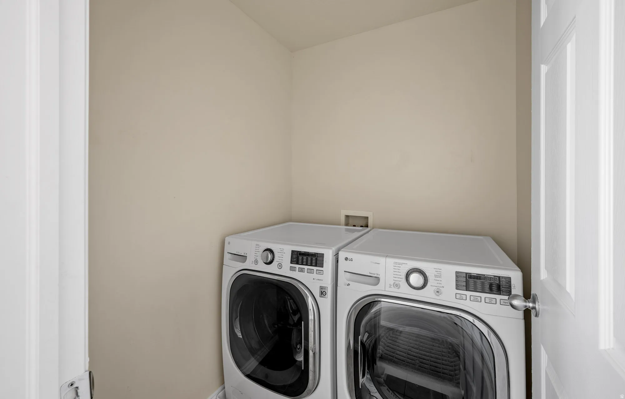 Laundry area with washing machine and dryer and baseboards