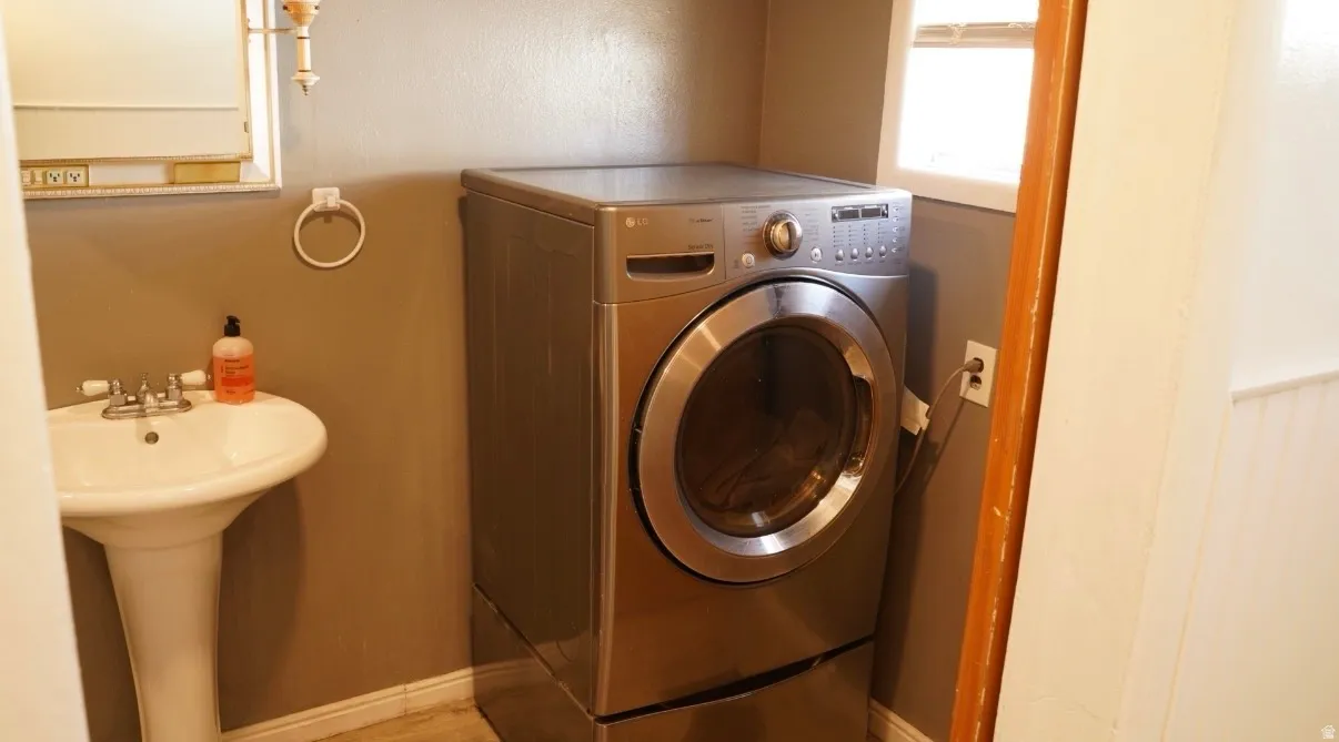 Laundry room featuring washer / clothes dryer and baseboards