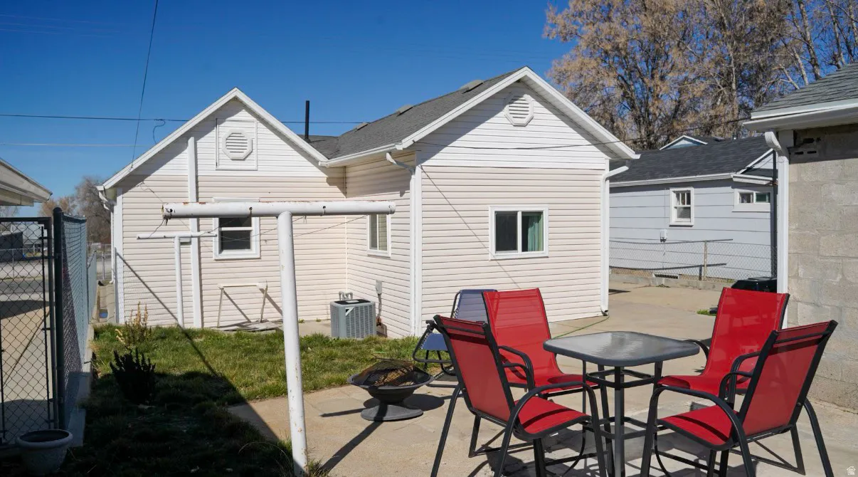 Back of property featuring a fire pit and a patio area
