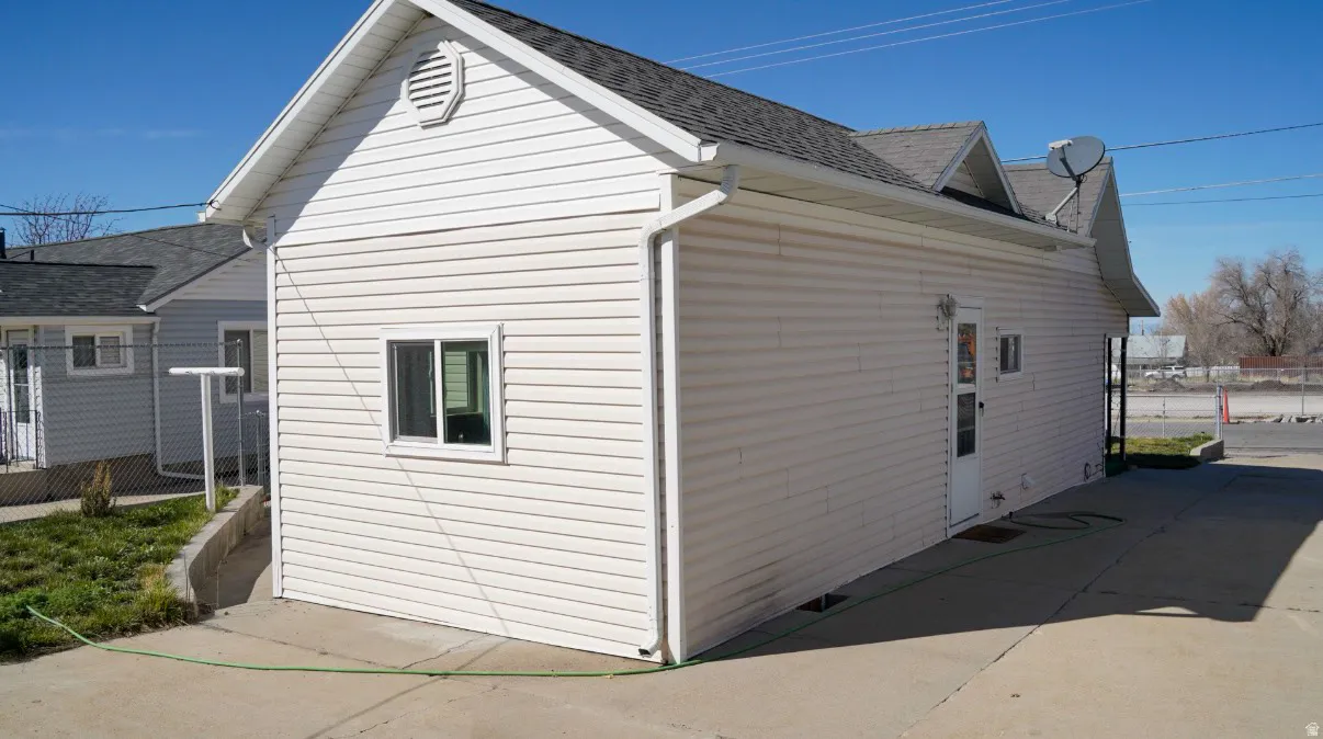 View of home's exterior with roof with shingles