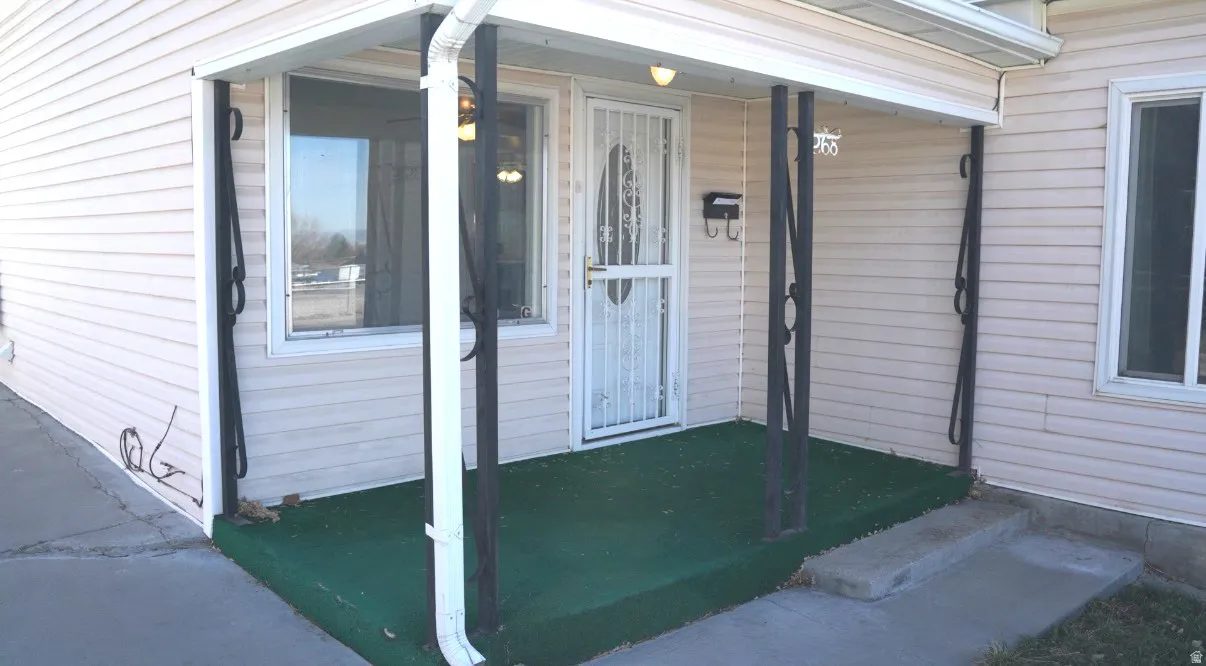 View of exterior entry featuring a porch