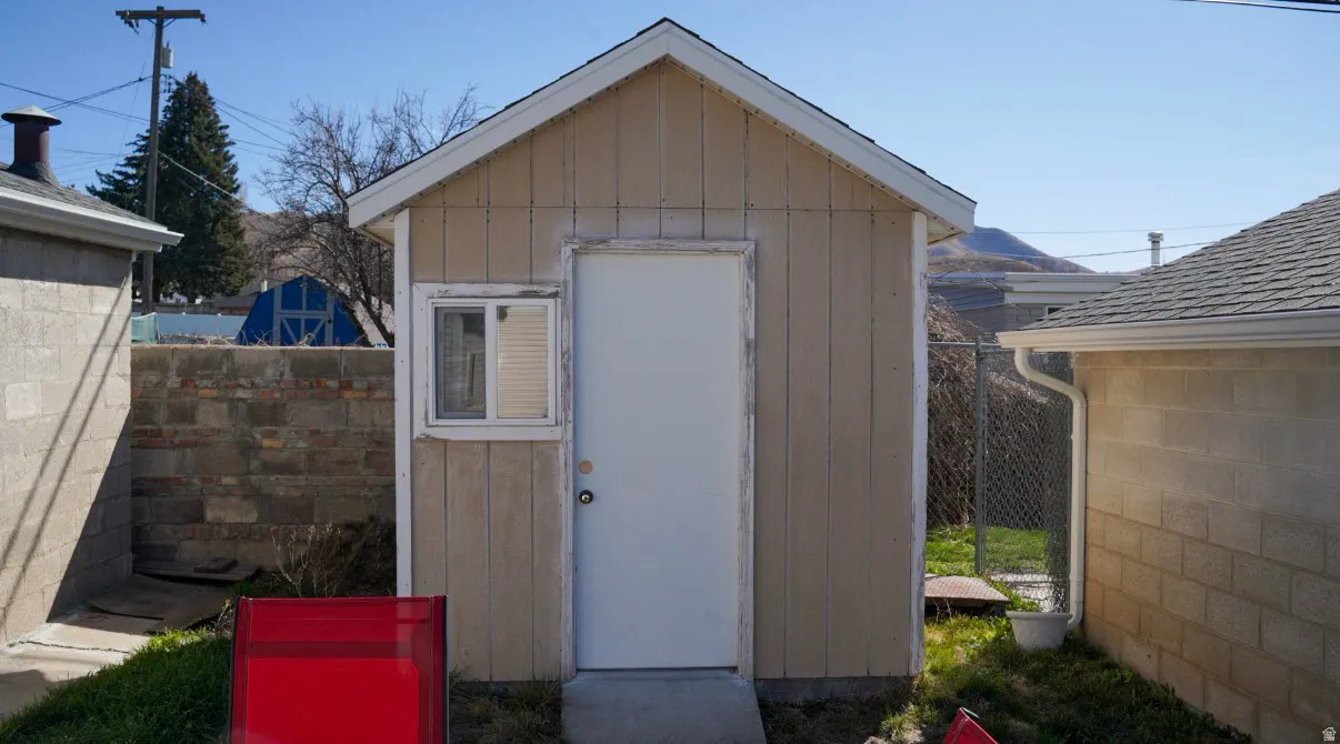 View of shed with a fenced backyard