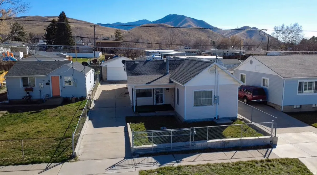 Aerial perspective of suburban area featuring a mountain backdrop