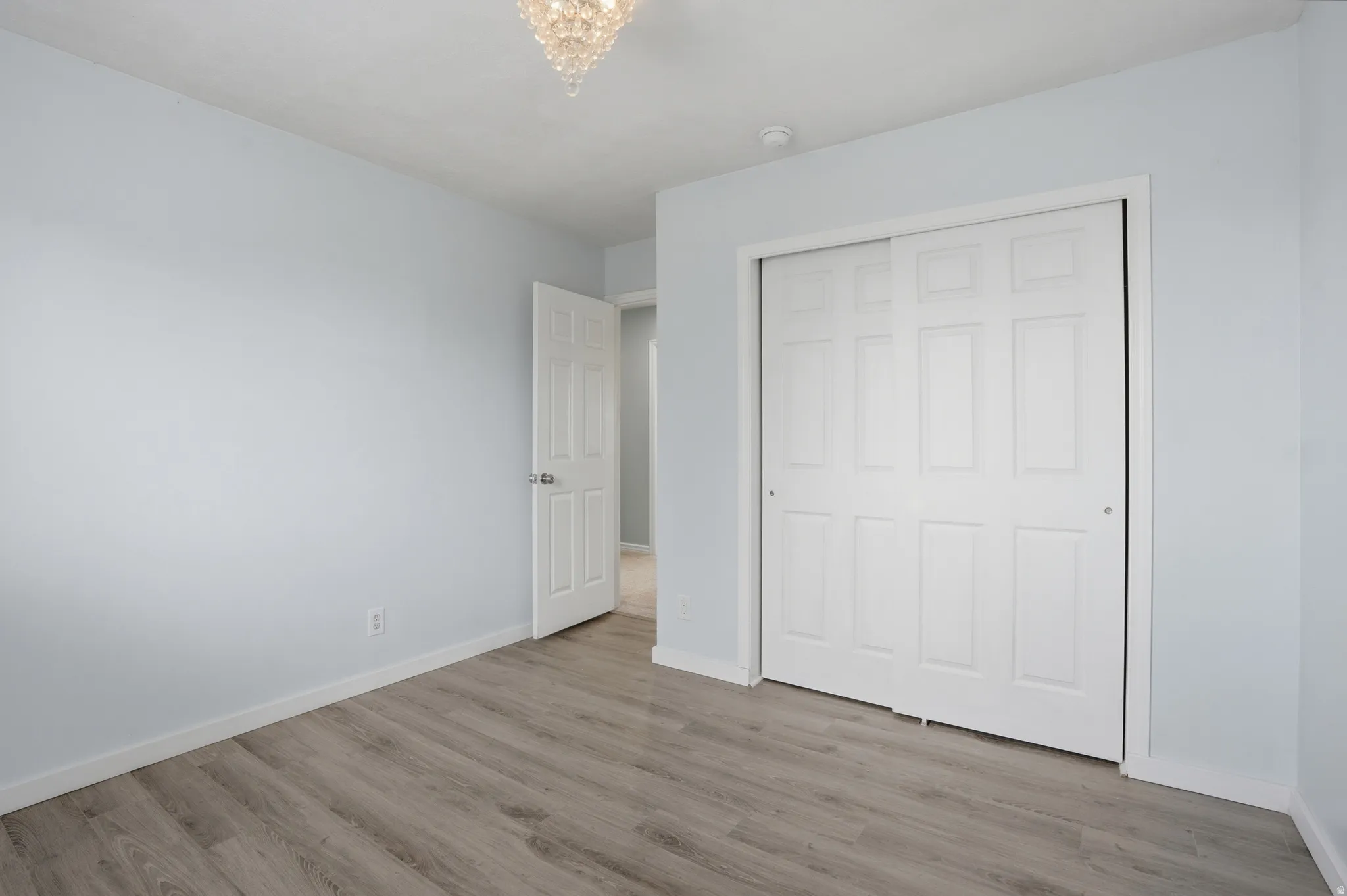 Unfurnished bedroom with light wood-style floors and a closet