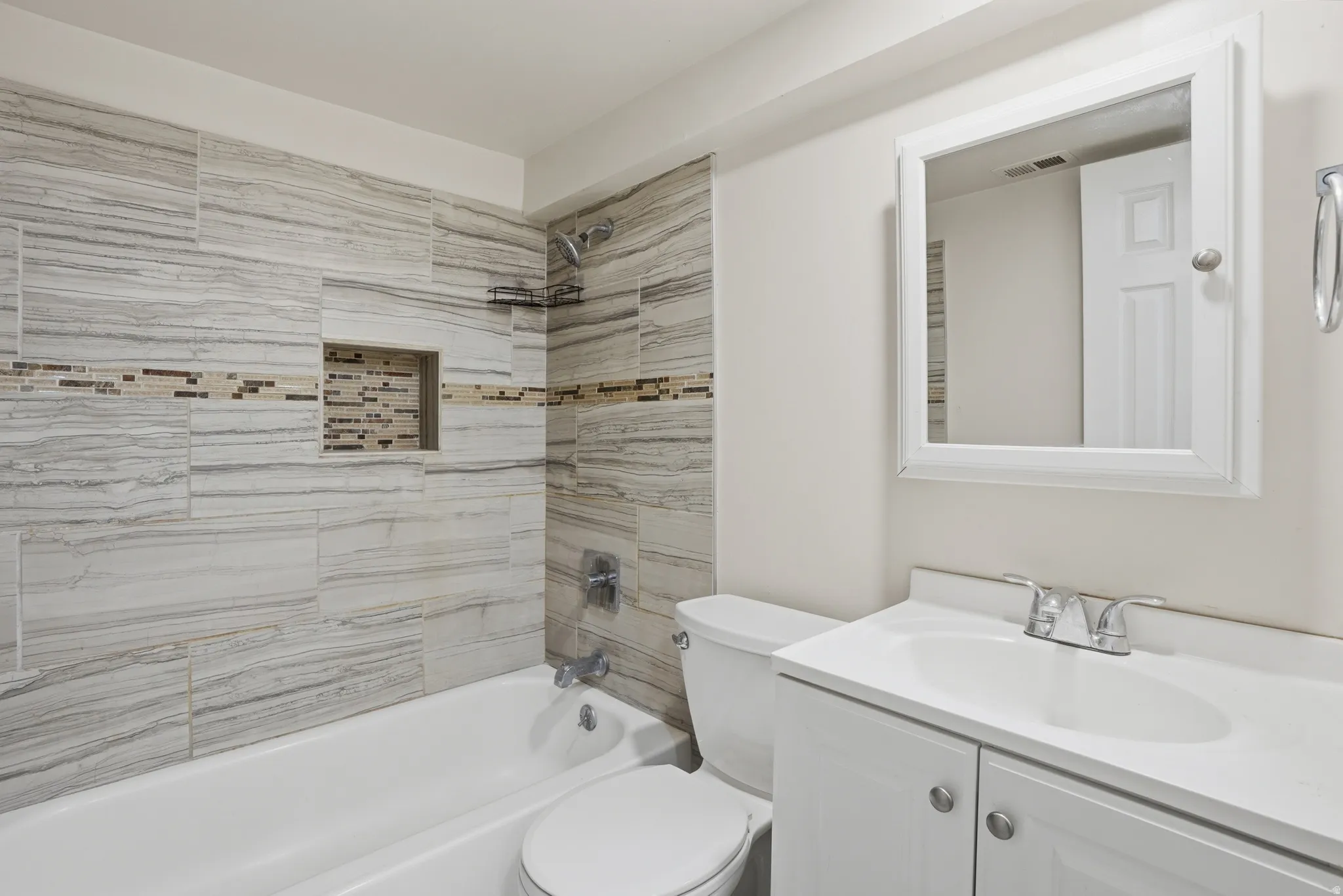 Bathroom featuring vanity and shower / bath combination