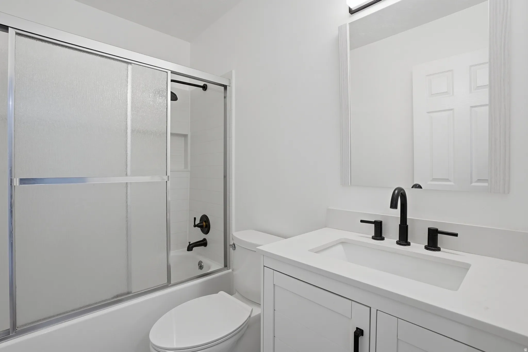 Full bath with vanity and shower / bath combination with glass door