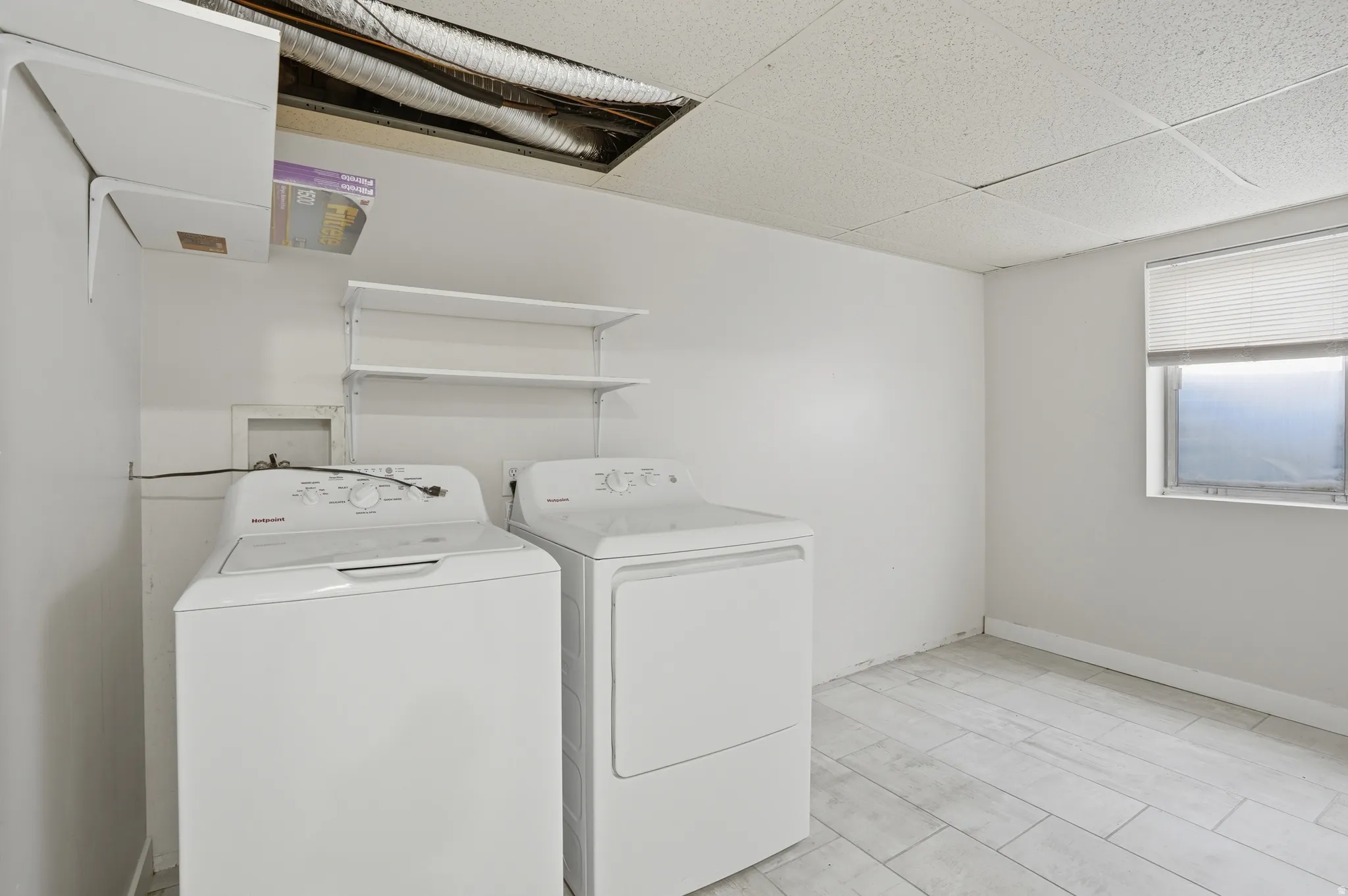 Laundry area featuring a paneled ceiling and separate washer and dryer