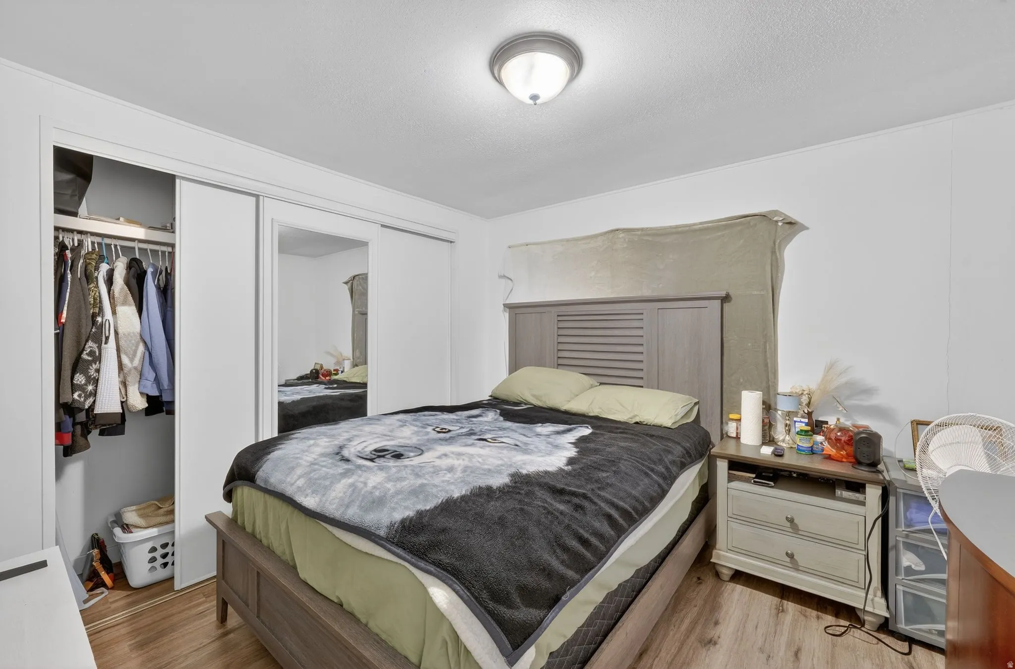 Bedroom with a closet and light wood-type flooring