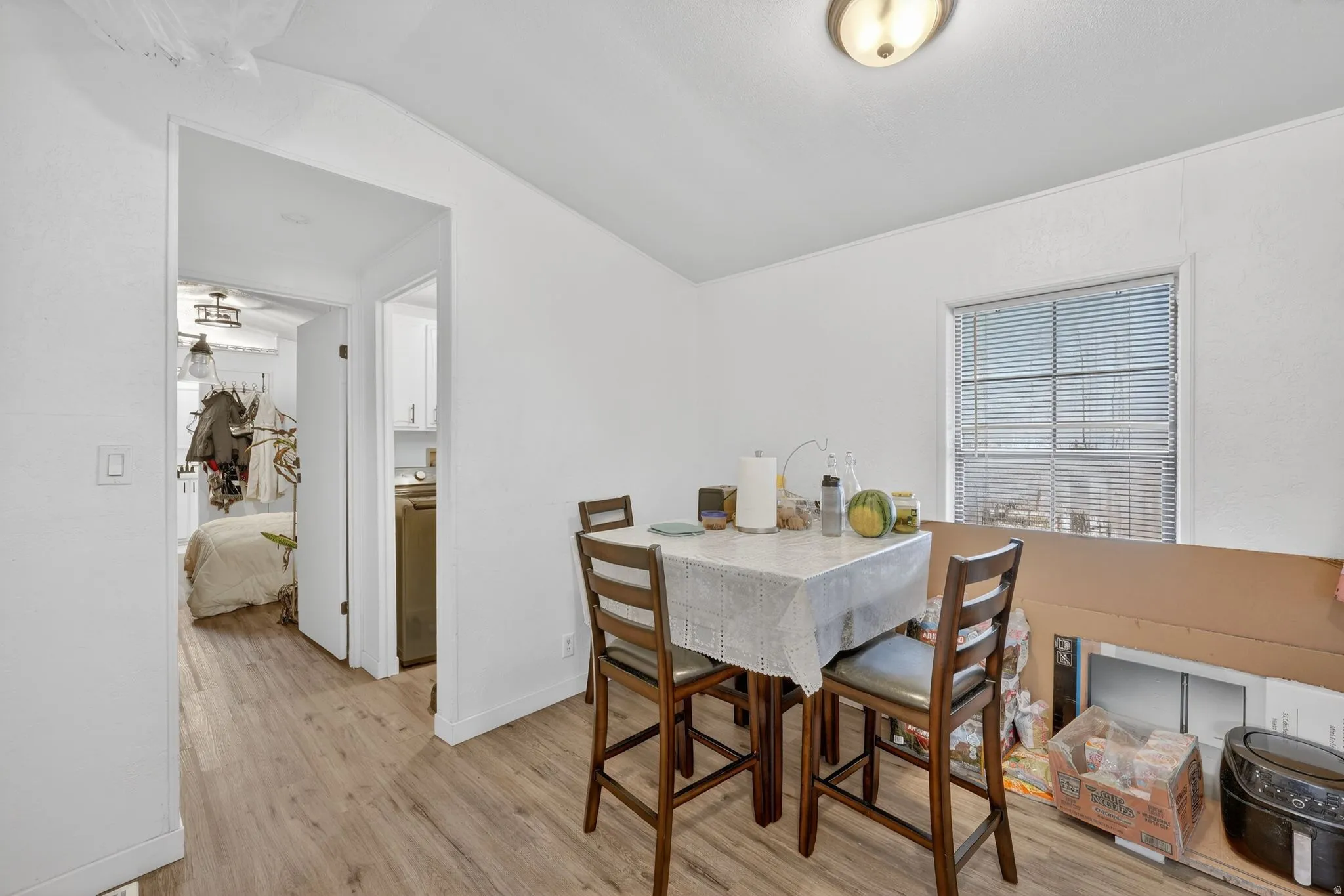 Dining room featuring light wood finished floors and lofted ceiling