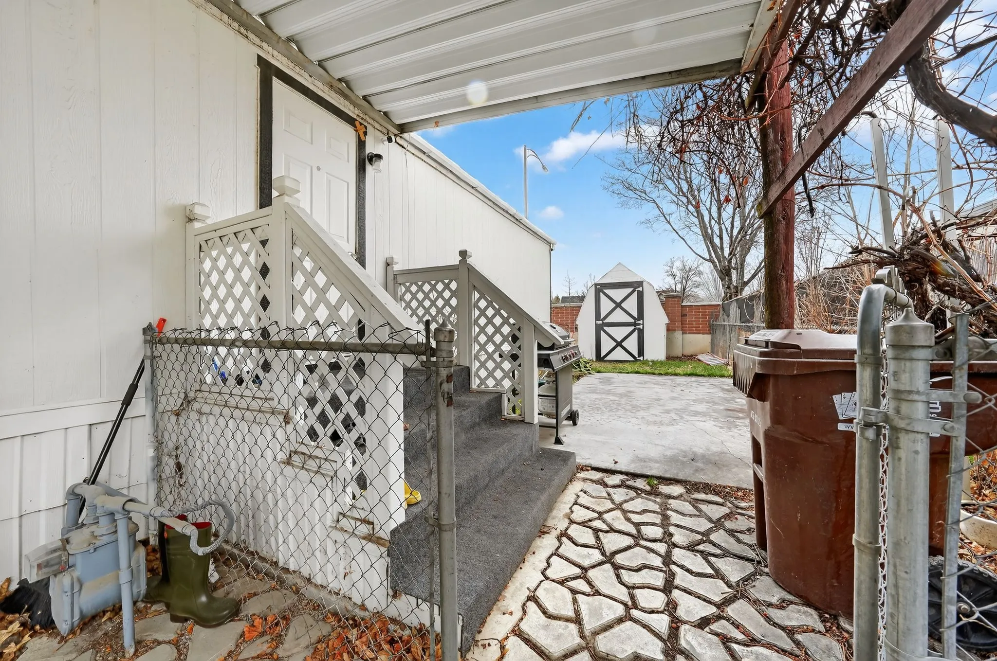 View of patio featuring a shed