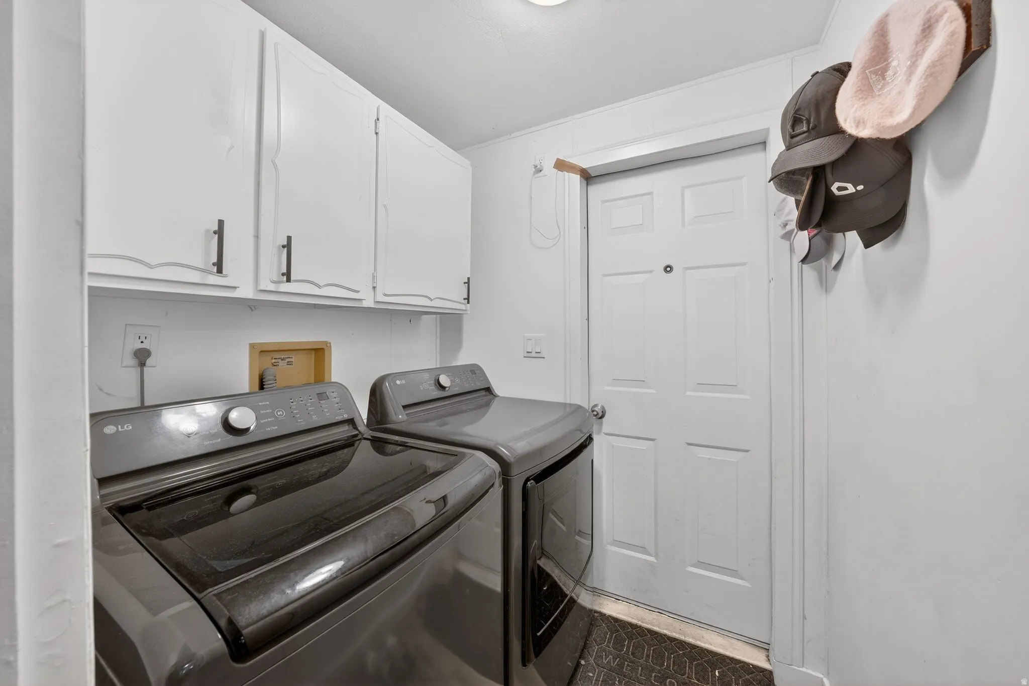 Laundry area with cabinet space and washer and clothes dryer