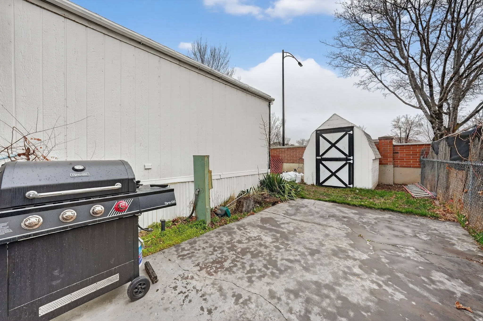 View of patio / terrace featuring grilling area and a storage shed