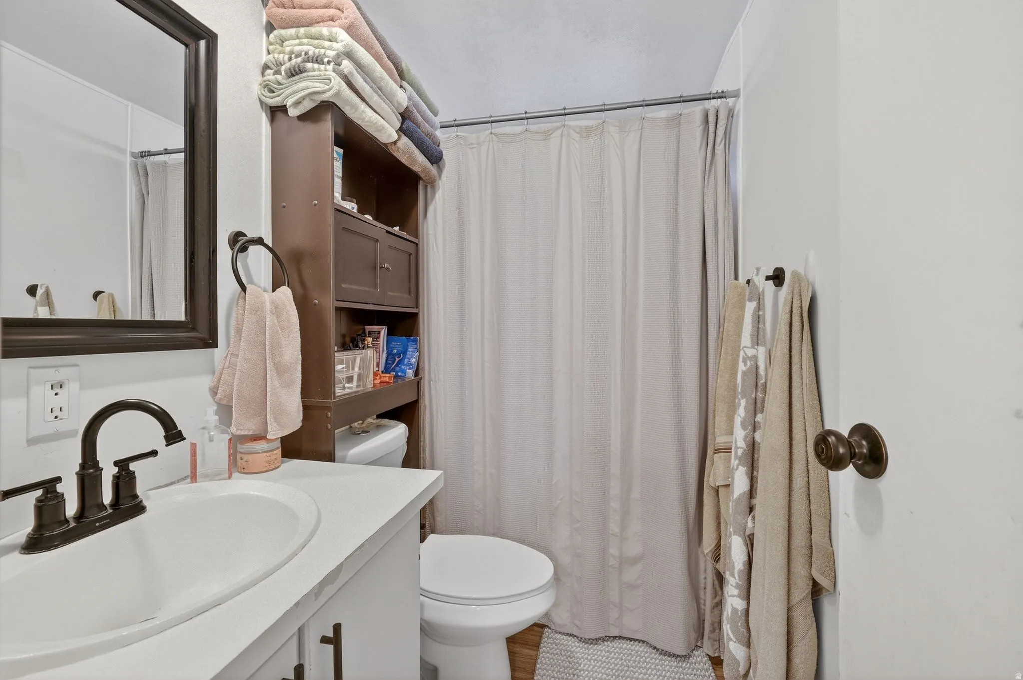 Bathroom featuring vanity and curtained shower
