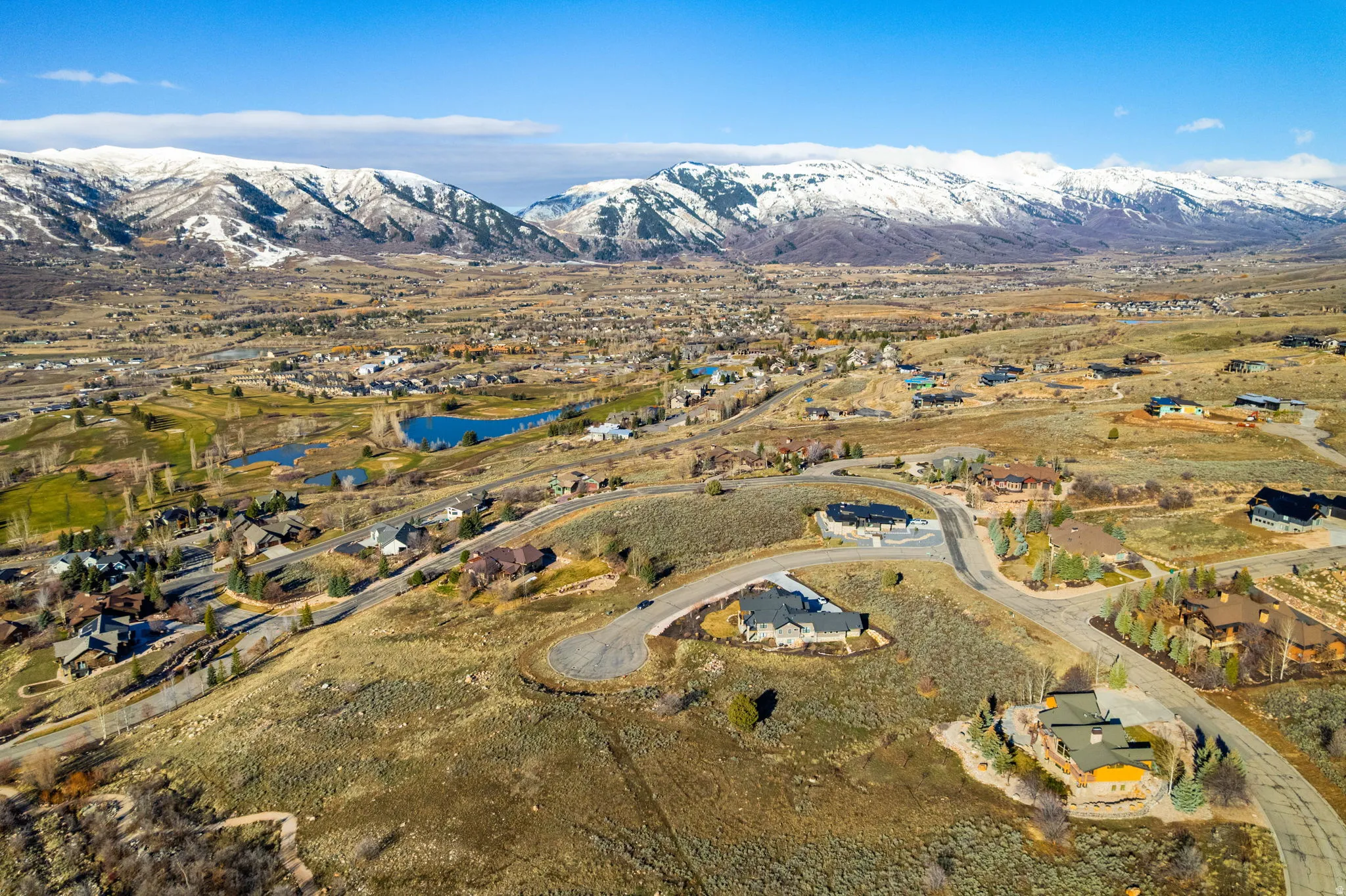 Aerial overview of property's location with nearby suburban area and a water and mountain view