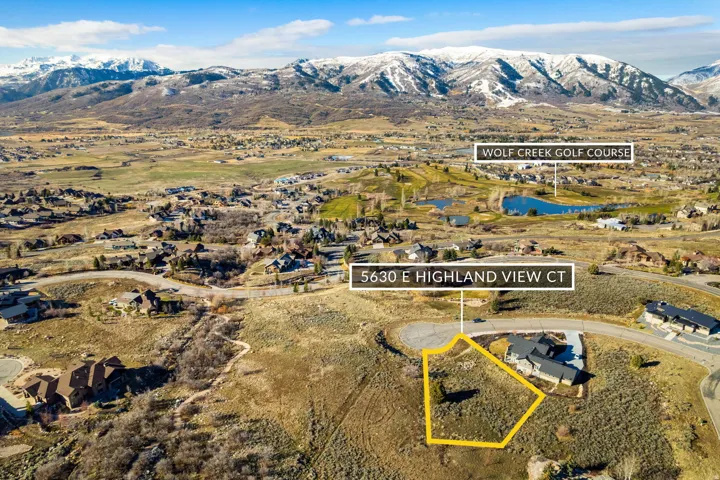 Aerial view of residential area featuring property parcel outlined and a water and mountain view