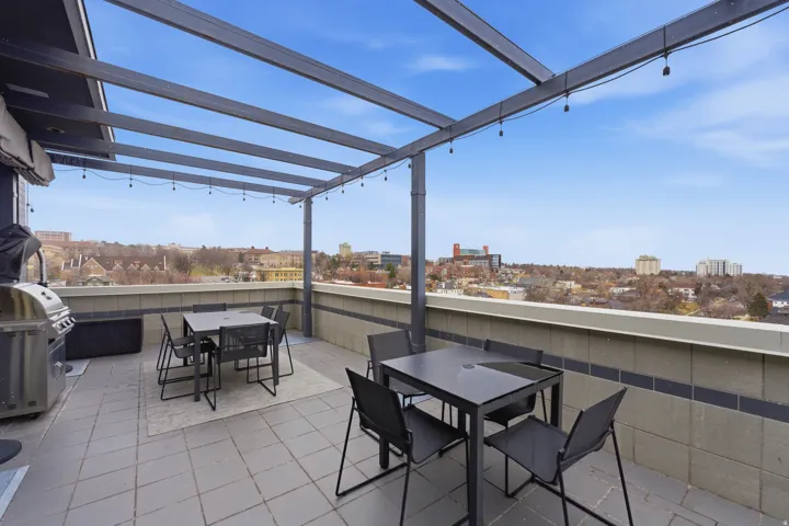 View of patio / terrace with outdoor dining area, a view of city, and a grill
