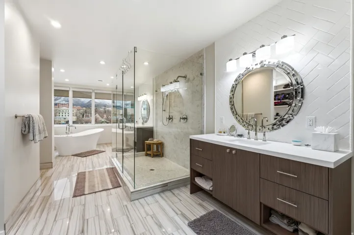 Full bath featuring vanity, a shower stall, a freestanding bath, and recessed lighting