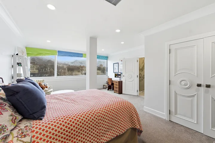 Bedroom featuring ornamental molding, light carpet, and recessed lighting