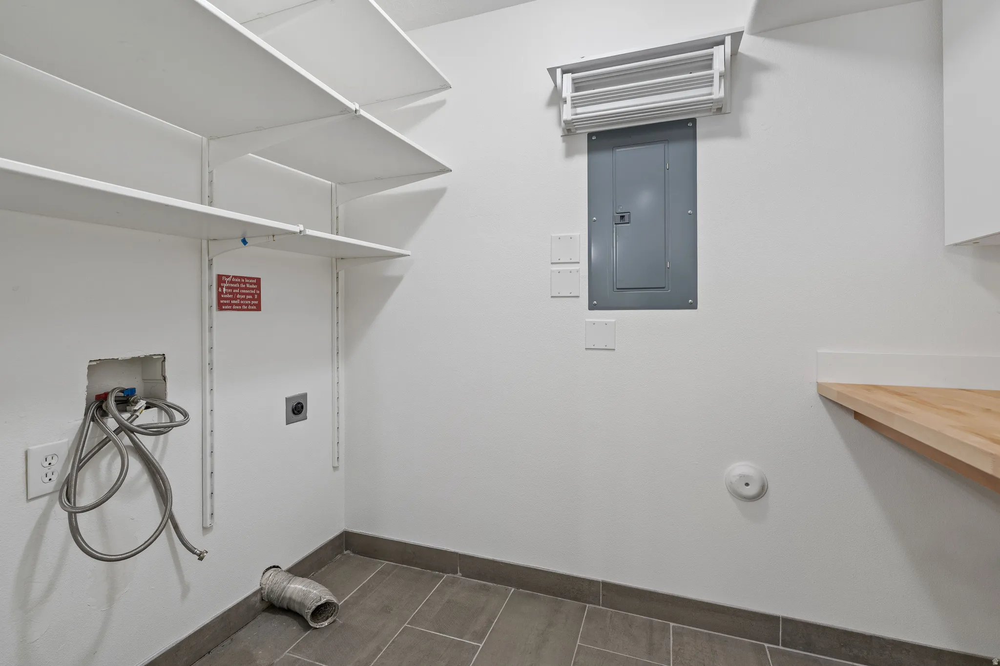 Laundry area with washer hookup, electric panel, and hookup for an electric dryer