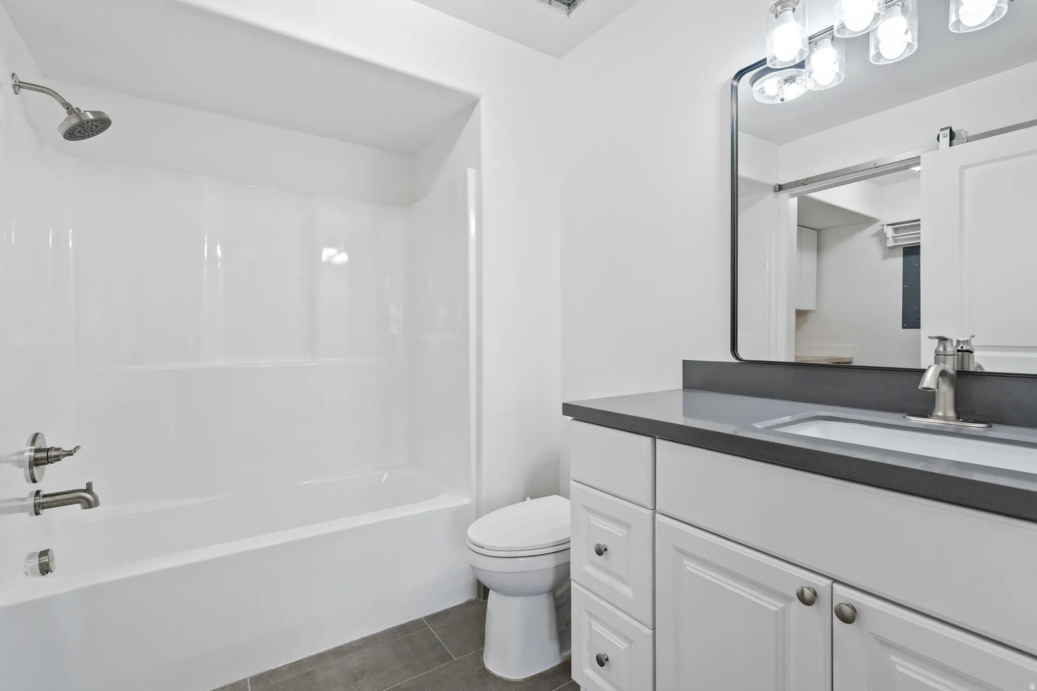 Bathroom featuring vanity and  shower combination