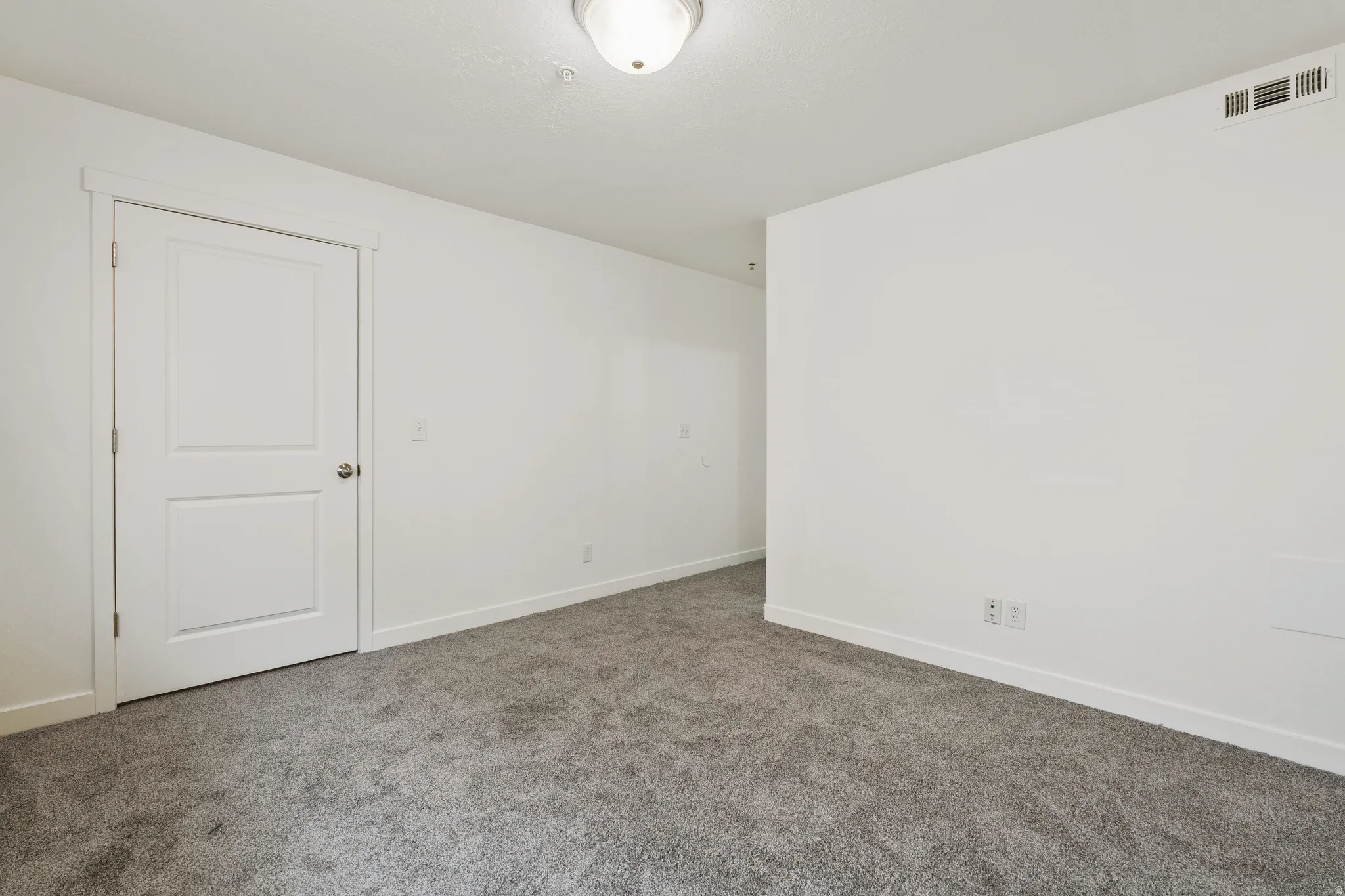 Spare room with baseboards and carpet