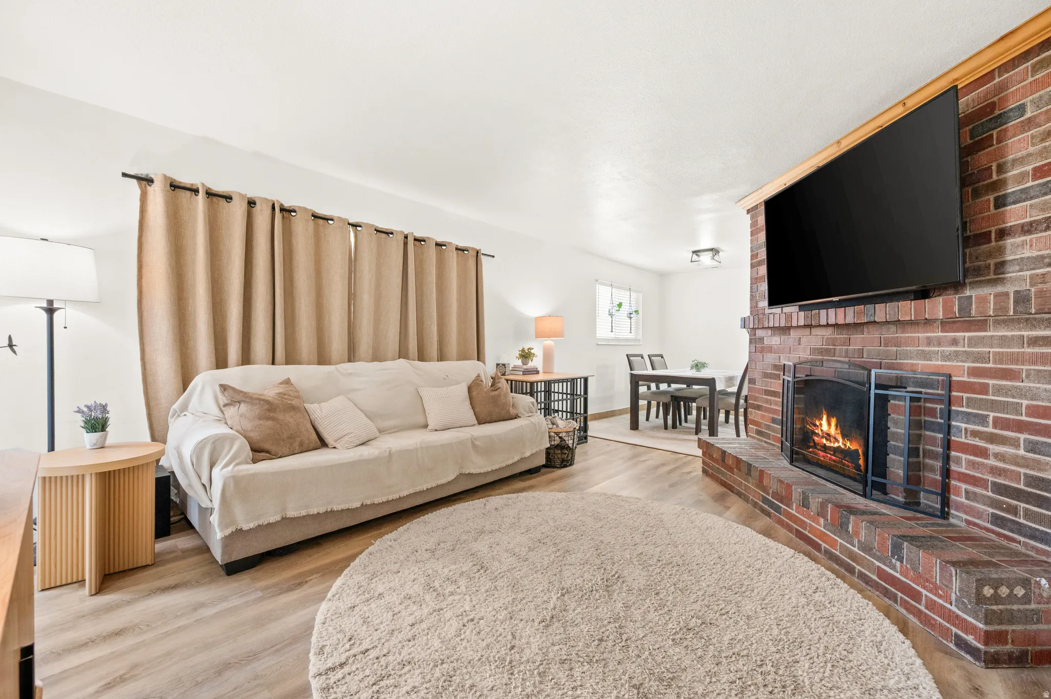 Living room featuring light wood-style floors and a fireplace