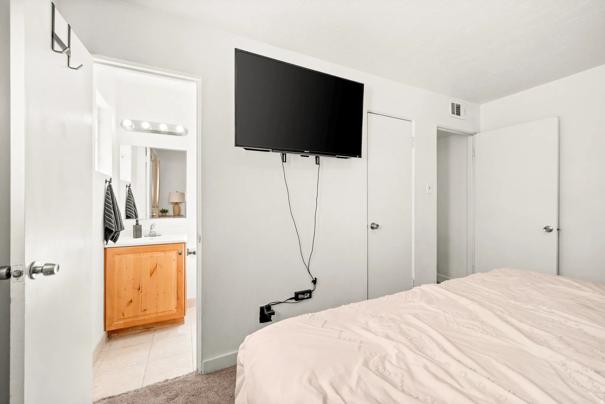 Bedroom with light tile patterned flooring
