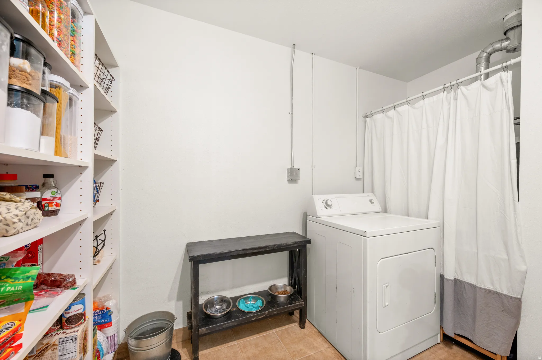 Laundry room featuring washer / clothes dryer and light tile patterned floors