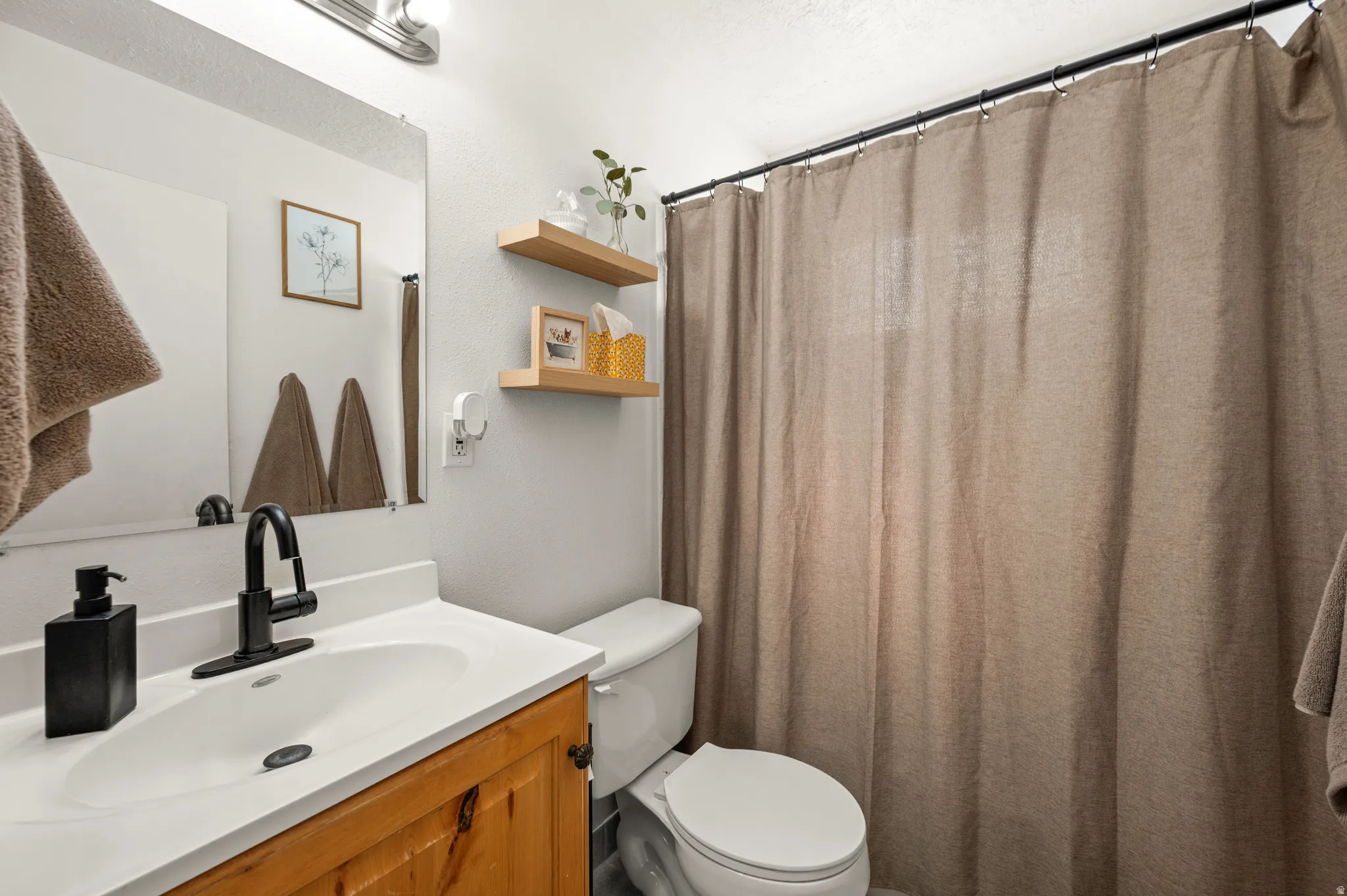 Full bath with vanity and a shower with curtain