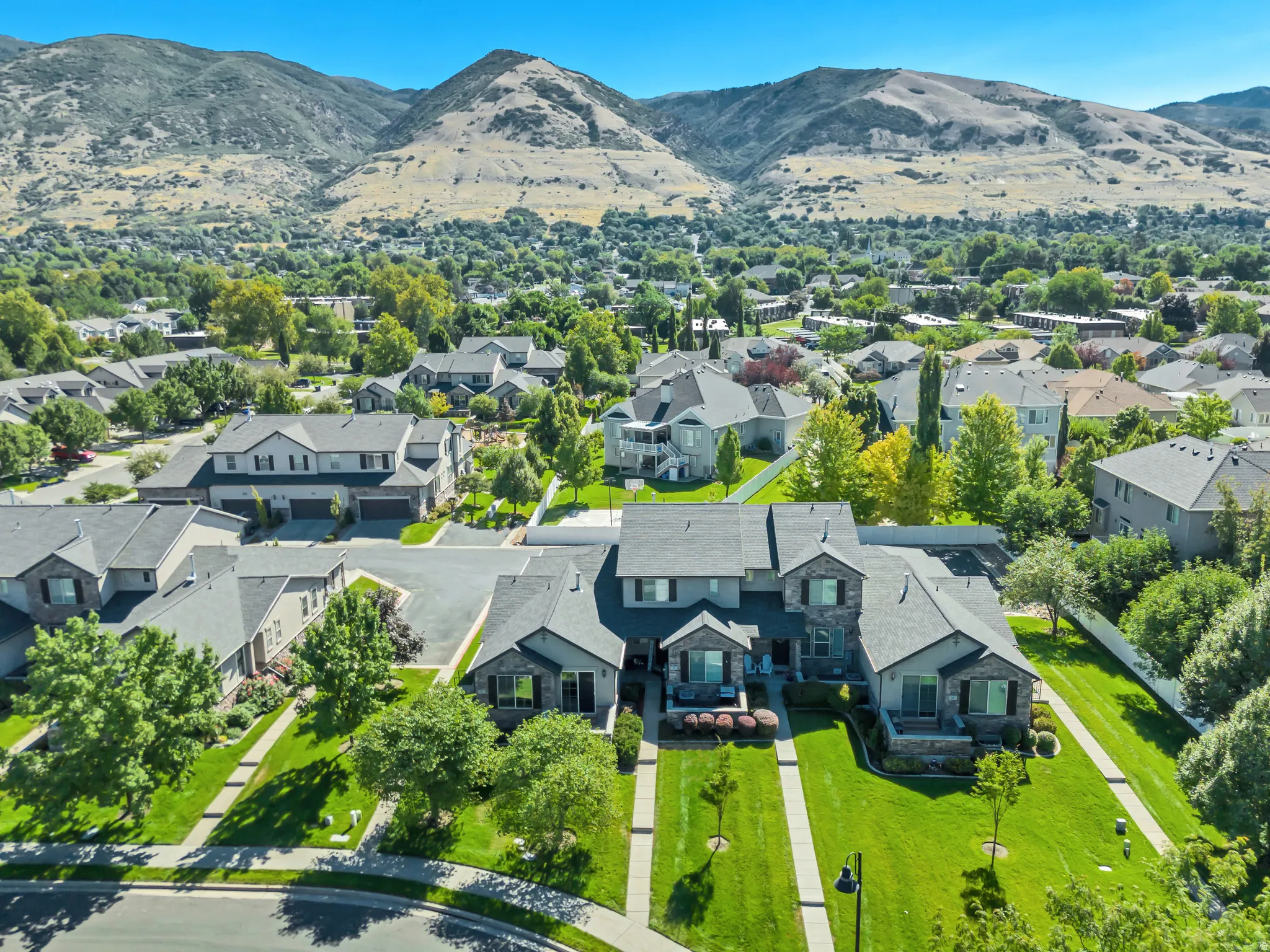 Aerial perspective of suburban area with a mountain backdrop
