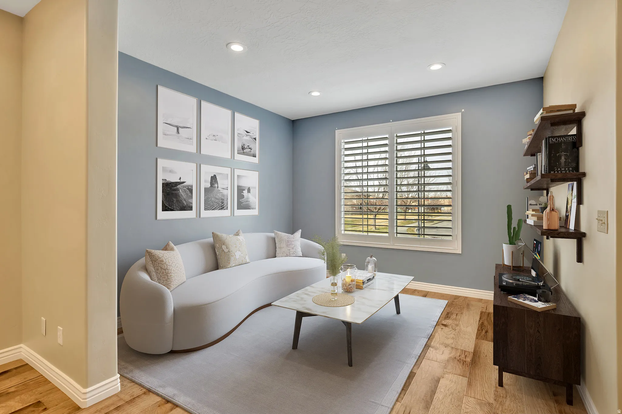 Living area featuring light wood-style floors and recessed lighting