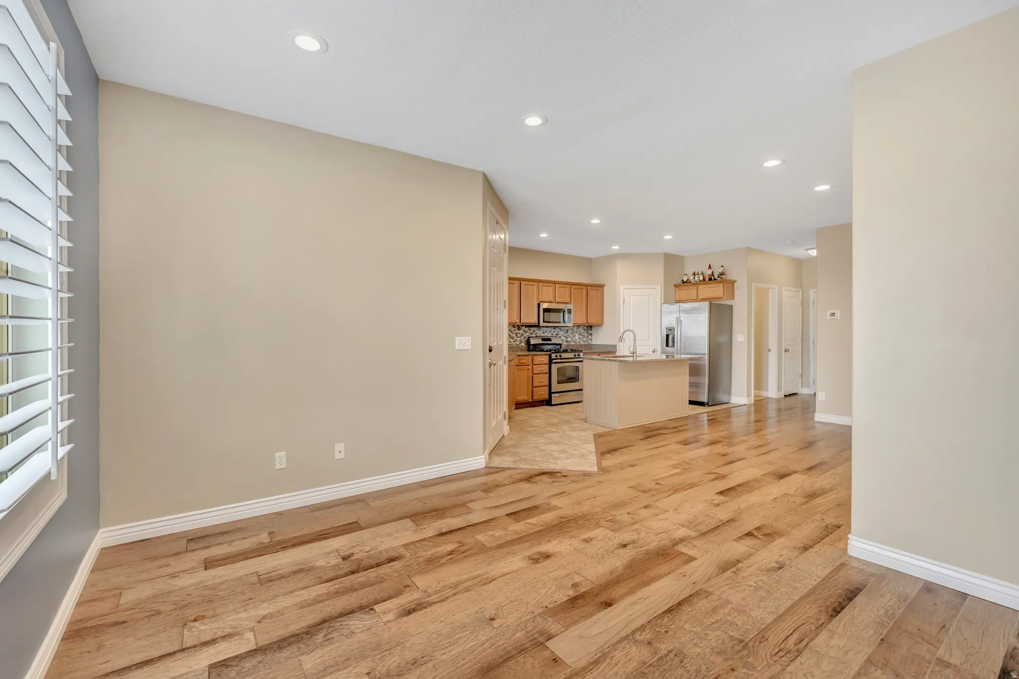 Unfurnished living room with light wood-type flooring and recessed lighting