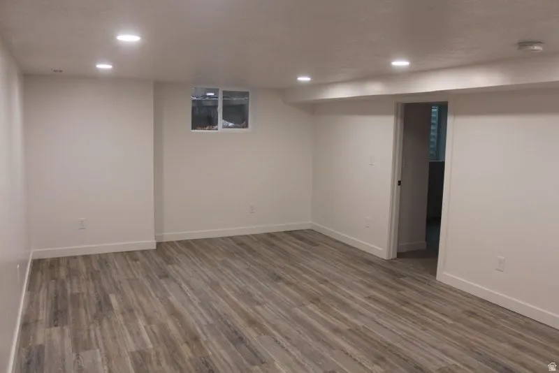 Finished below grade area featuring wood finished floors and recessed lighting
