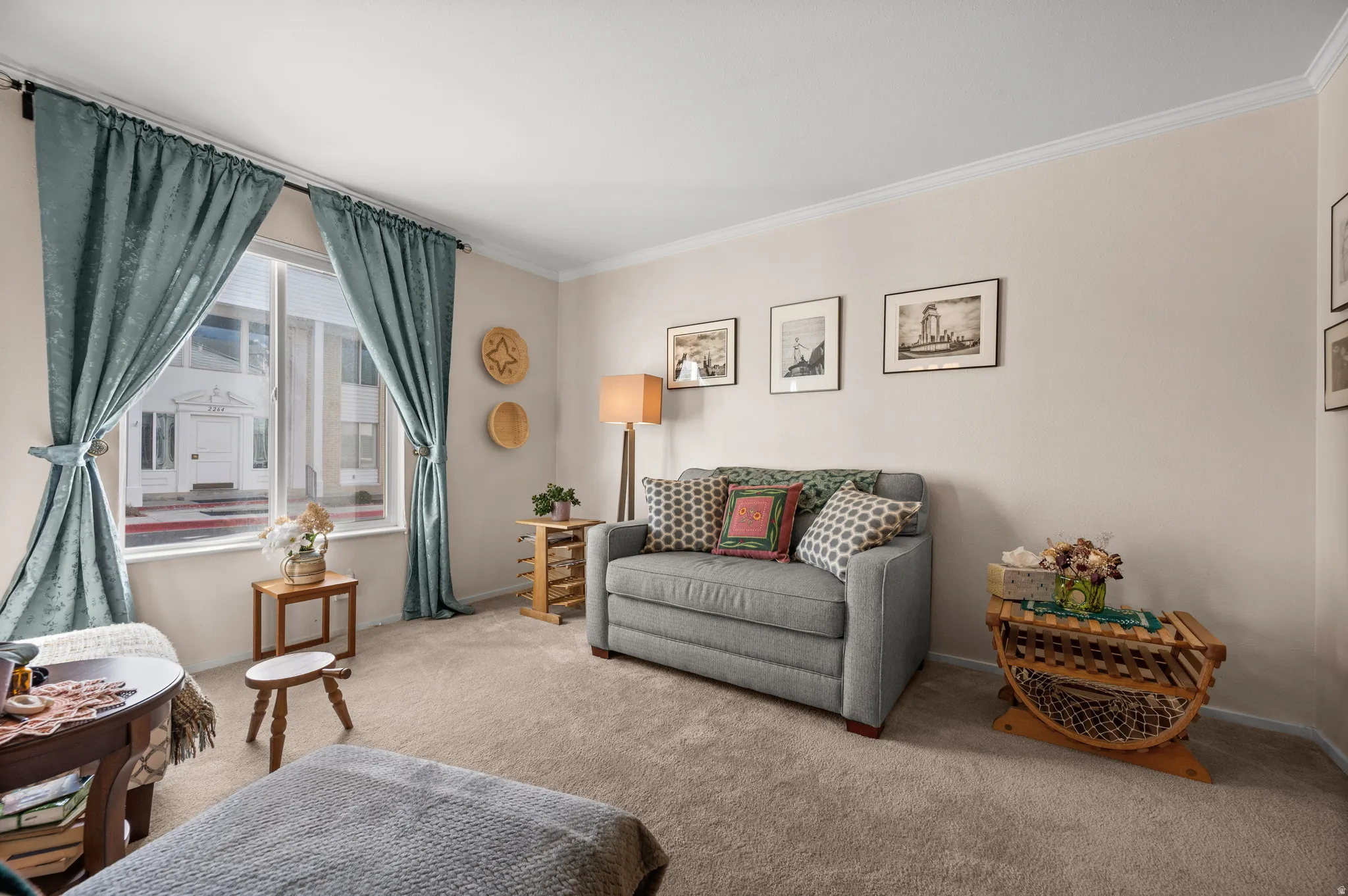 Living room featuring light carpet and ornamental molding
