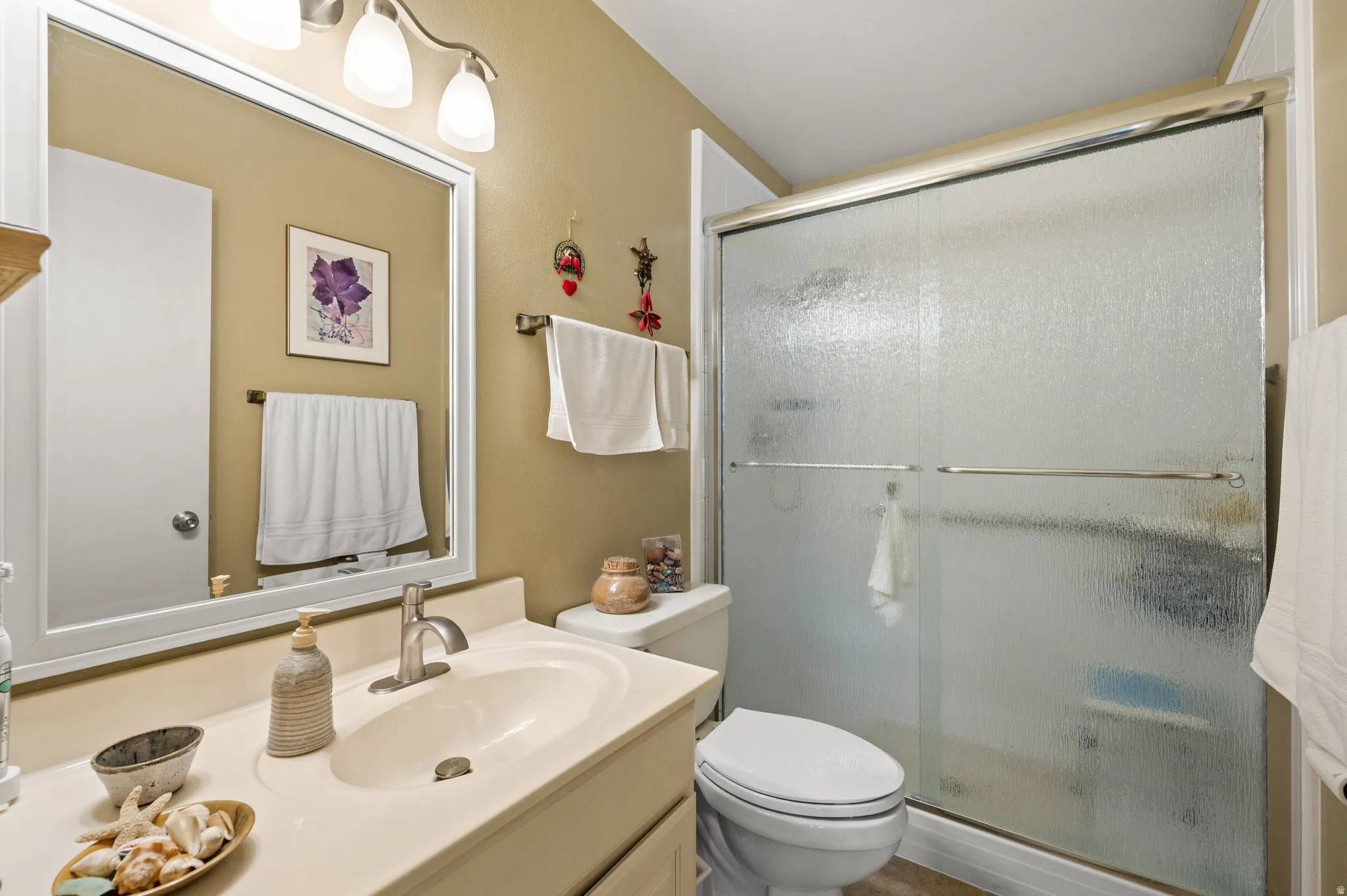 Bathroom with vanity and a stall shower