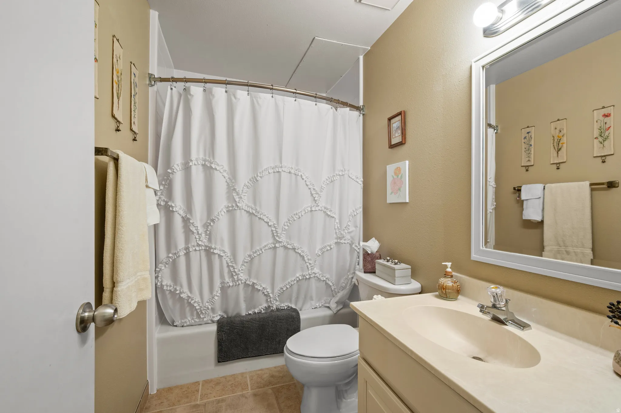Full bathroom with vanity, shower / bath combo, and light tile patterned floors