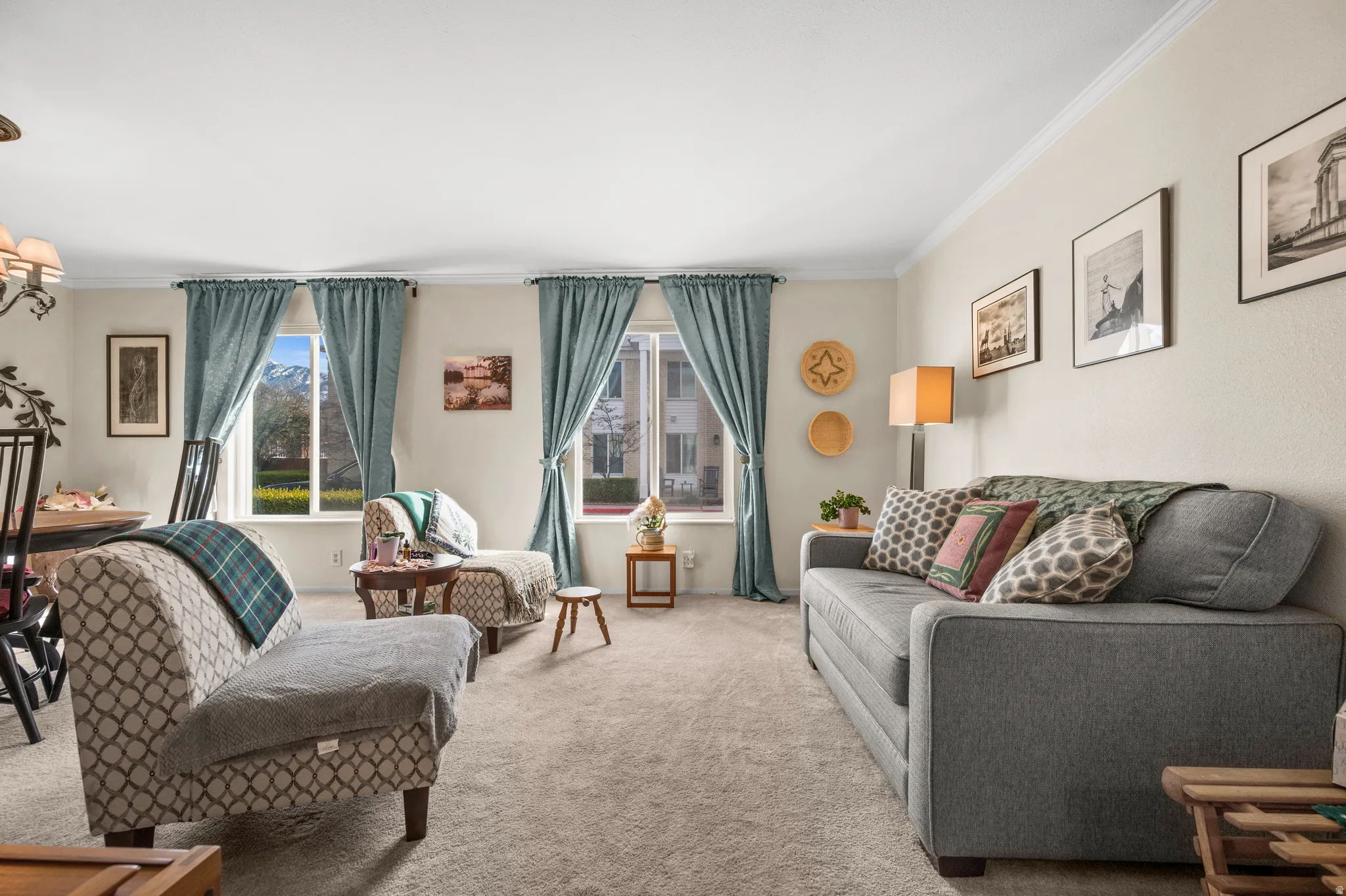 Living area featuring crown molding and carpet floors