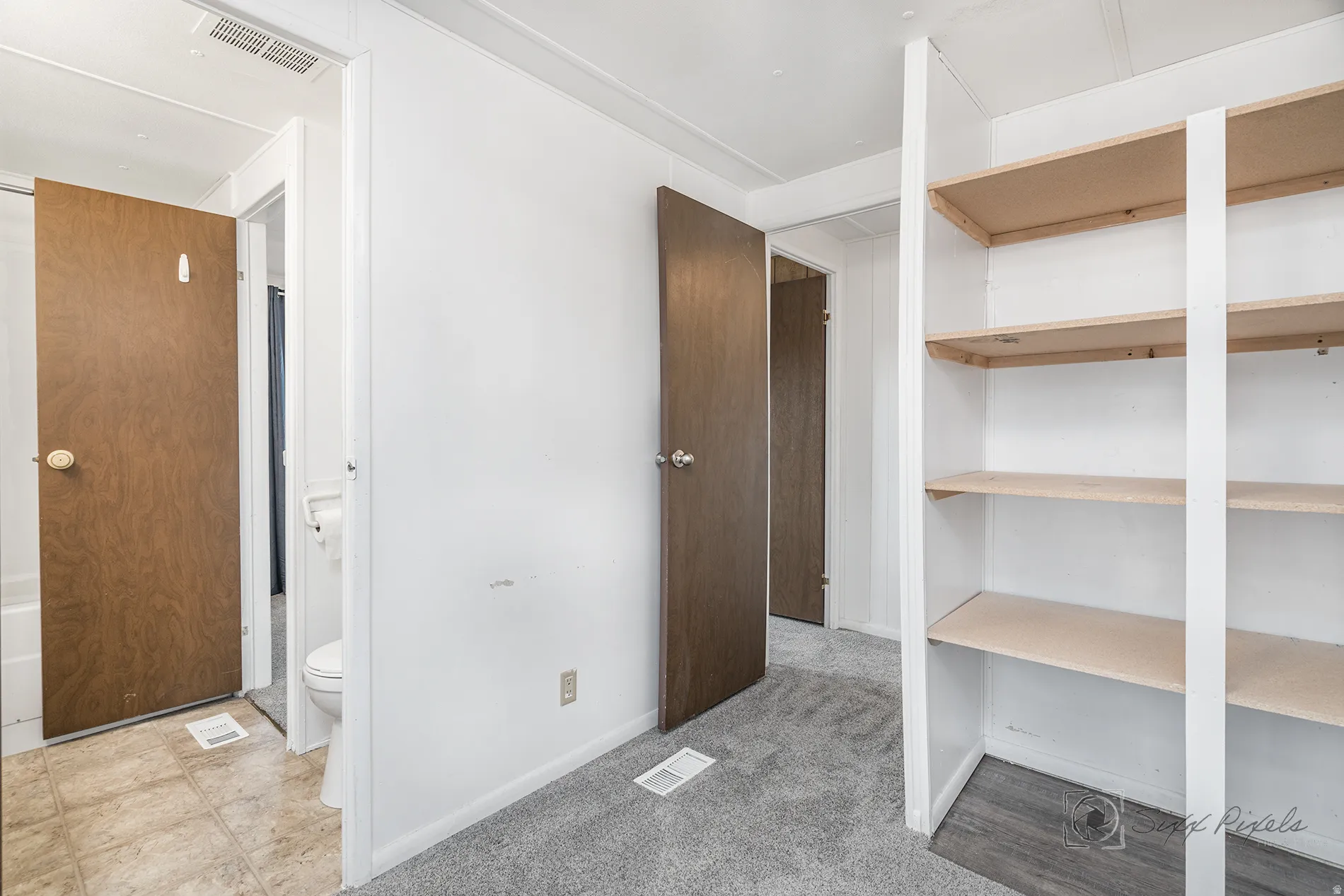 Interior space with light colored carpet and baseboards