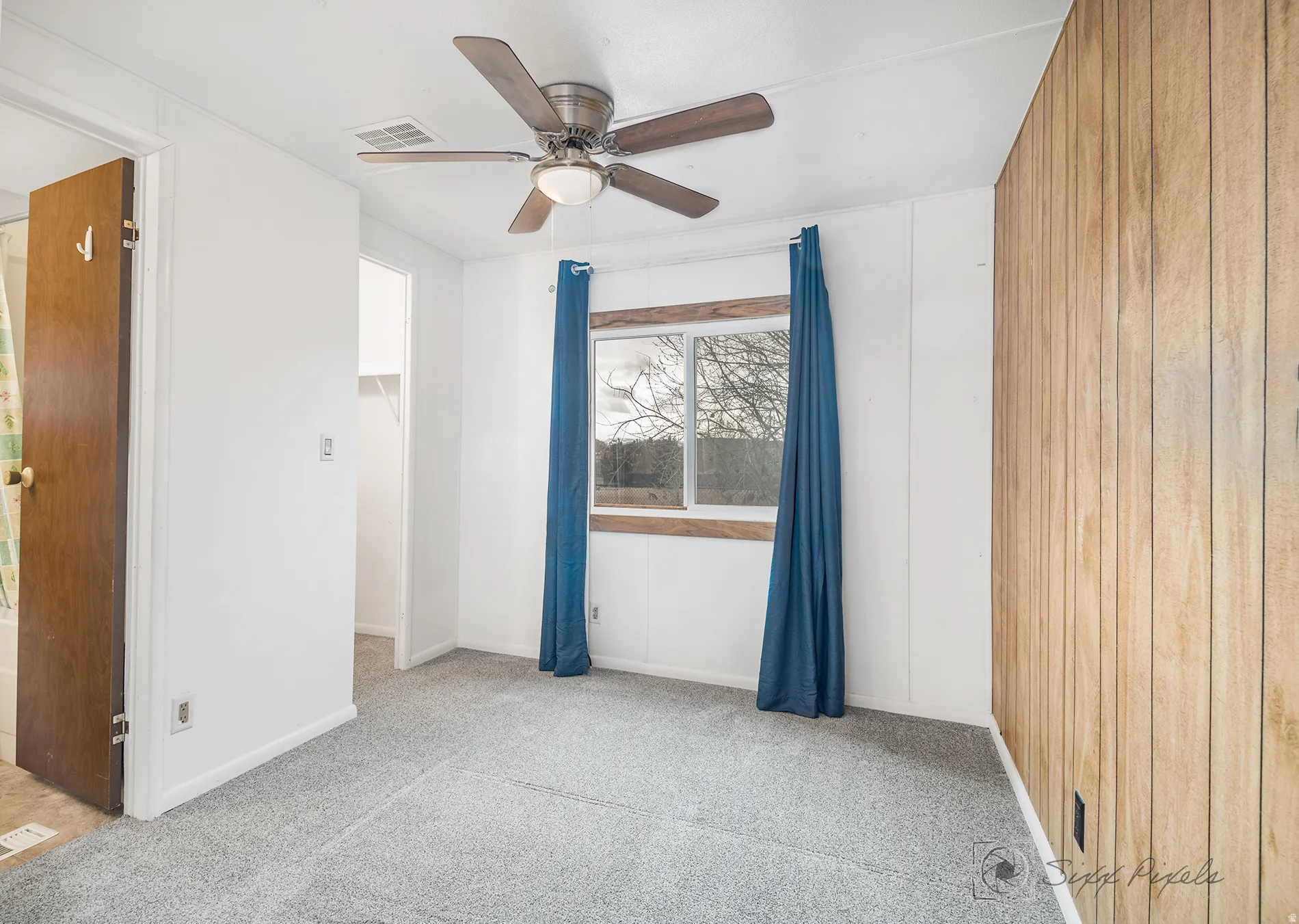 Empty room featuring light colored carpet and ceiling fan