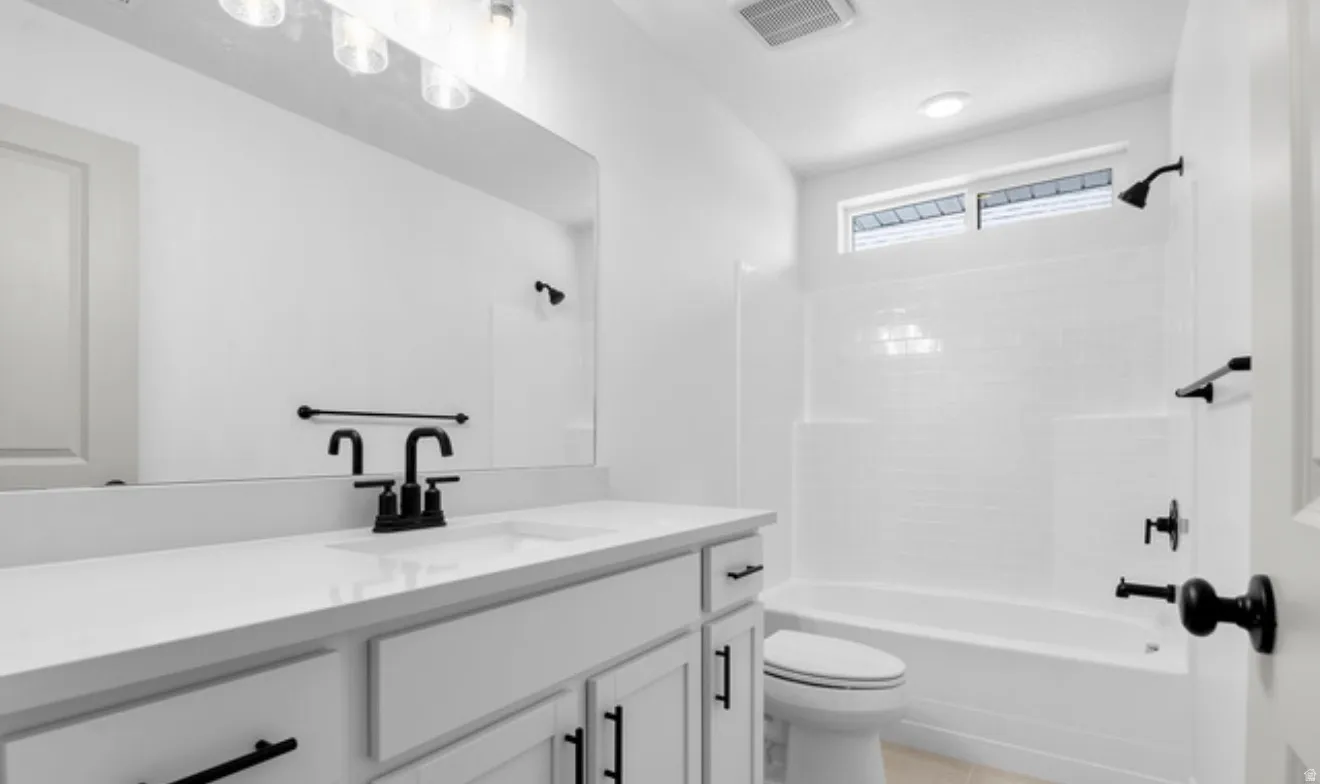 Full bath featuring vanity, bathing tub / shower combination, and light tile patterned floors