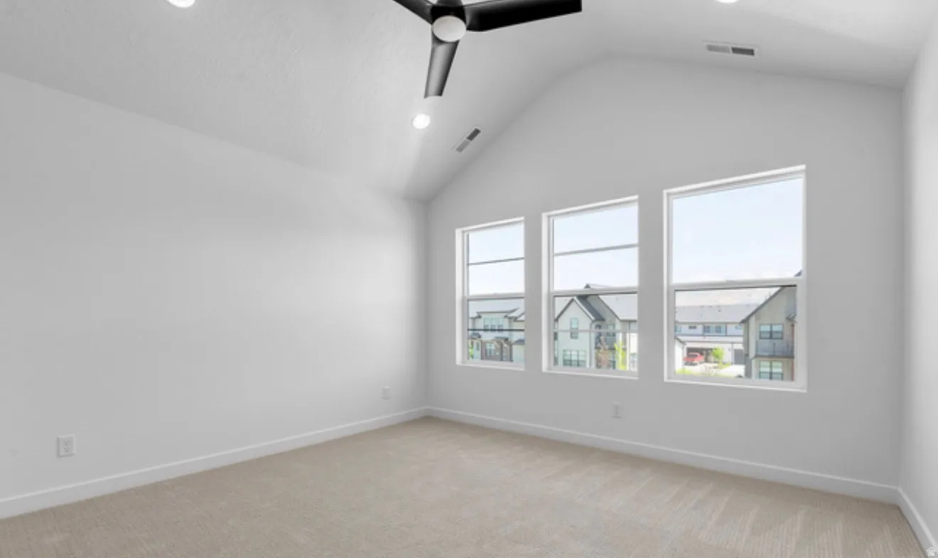 Empty room featuring light colored carpet, recessed lighting, and a ceiling fan