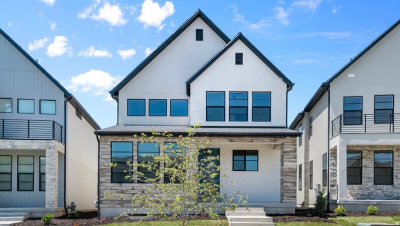View of front of property with brick siding and stucco siding