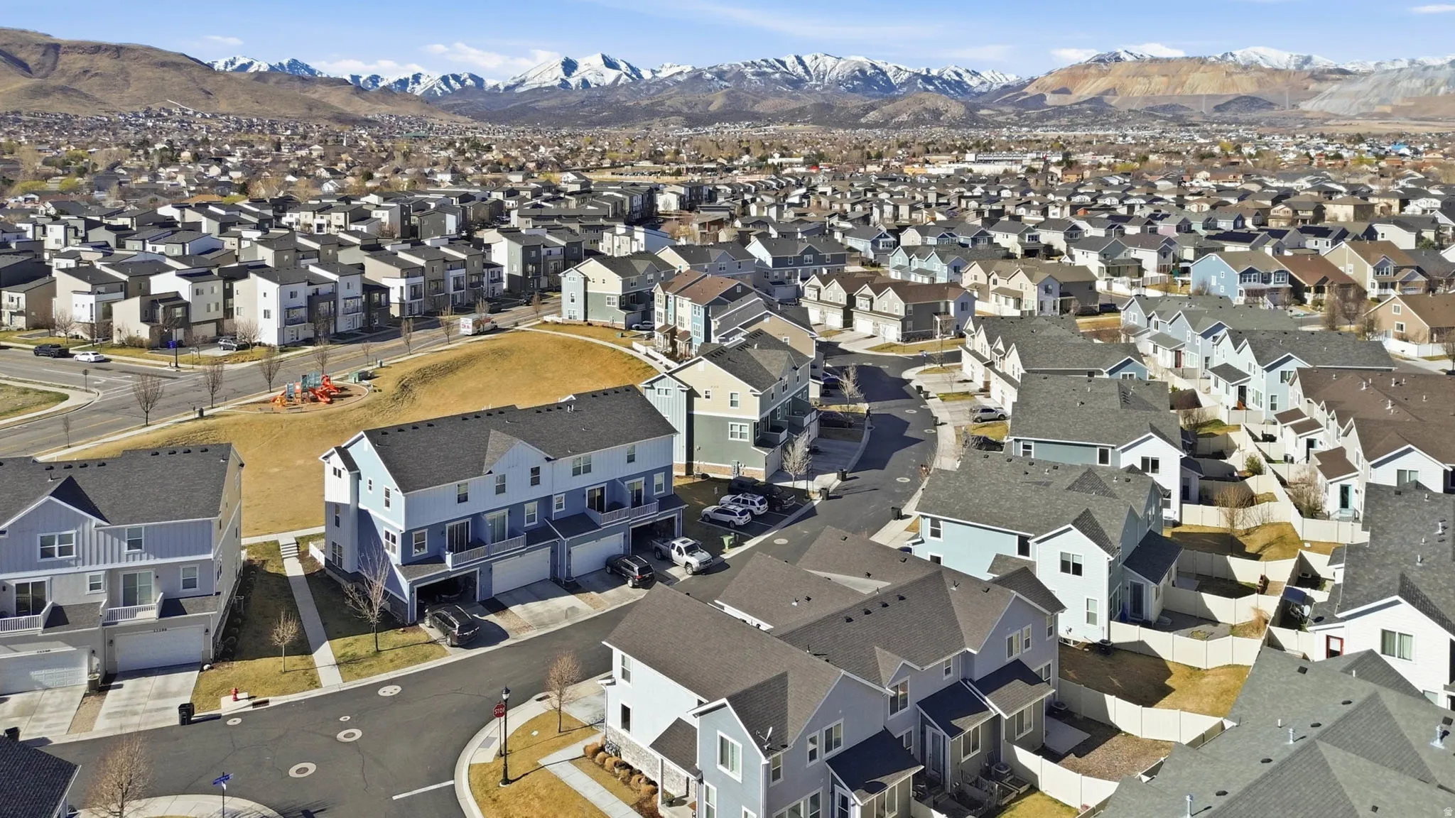 Aerial perspective of suburban area with a mountain backdrop