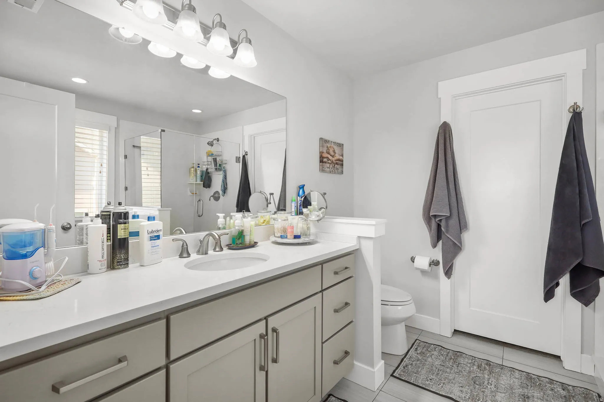 Bathroom with vanity, a shower stall, and recessed lighting