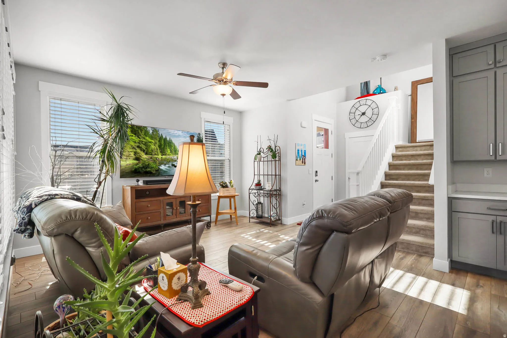Living room featuring ceiling fan and hardwood / wood-style floors